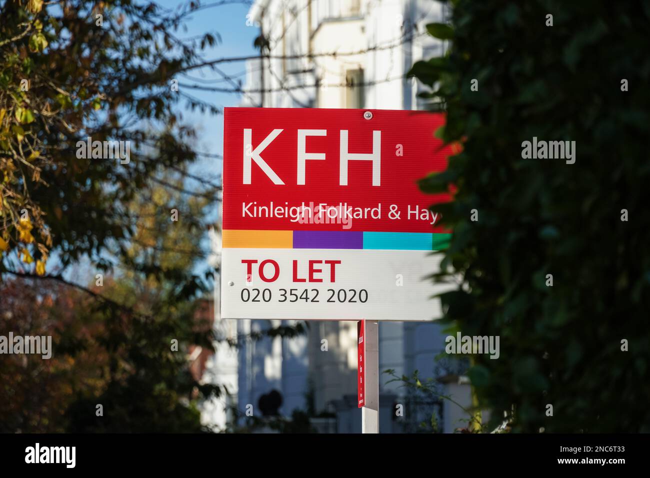 Real estate sign To Let outside terraced houses in Kensington London