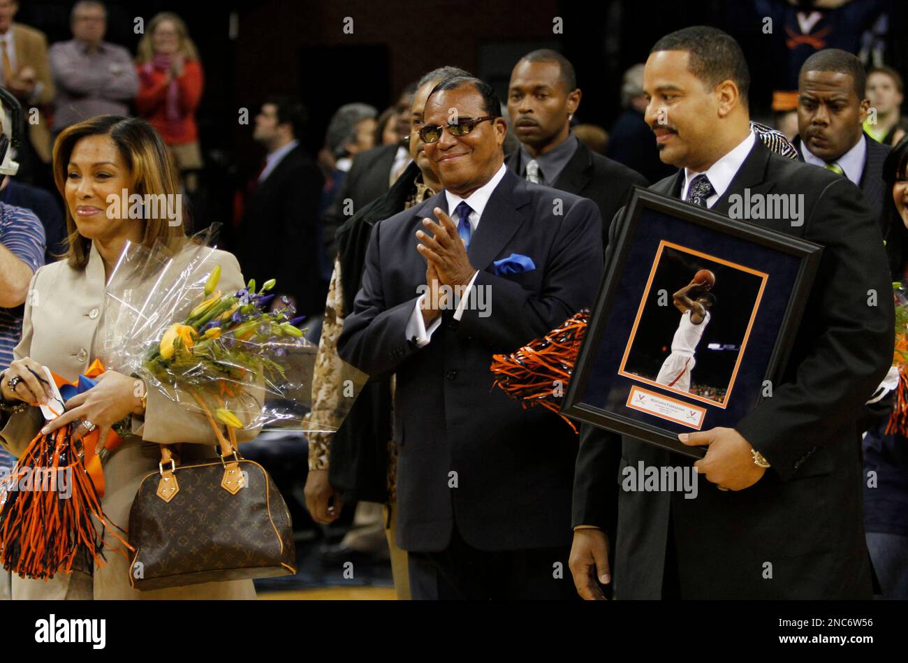 Nation of Islam Minister Louis Farrakhan, center, joins his son Mustapha  Farrakhan, right, and his son's wife, Karen Farrakhan, left, during pregame  ceremonies honoring Virginia seniors, including Mustapha Farrakhan, son of  Mustapha, image size:1300x949