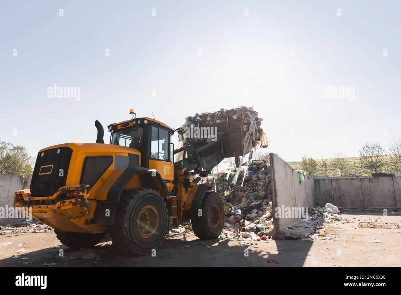 Heavy construction machine, front end loader moving along recycling
