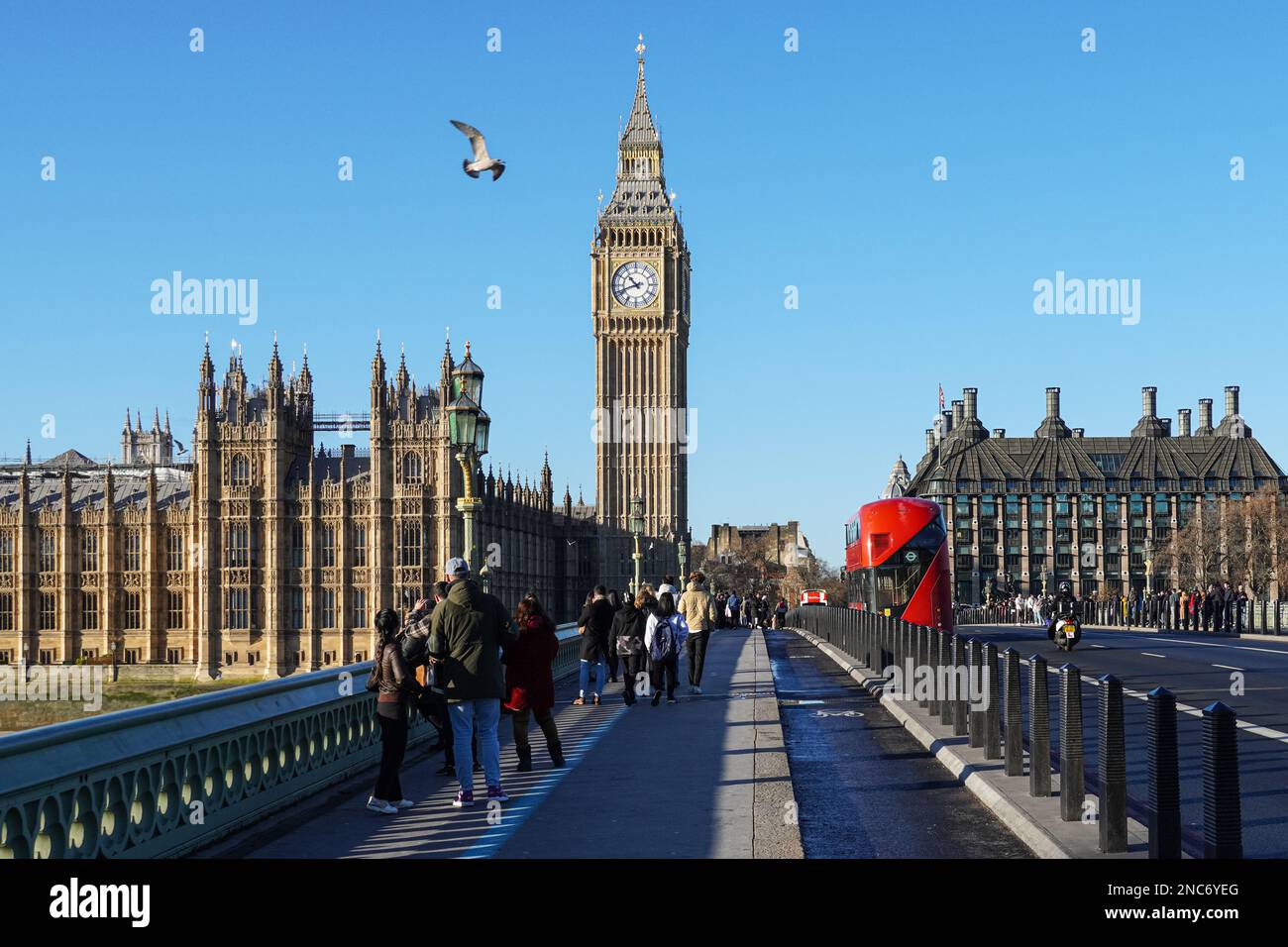 Tourists on Westminster Bridge with the Big Ben clock tower and the Palace of Westminster in the background, London England United Kingdom UK Stock Photo