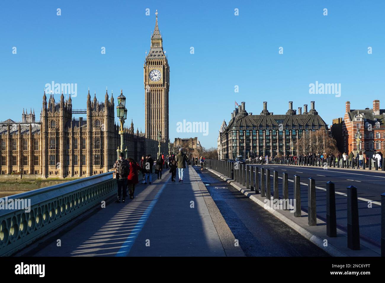 Tourists on Westminster Bridge with the Big Ben clock tower and the Palace of Westminster in the background, London England United Kingdom UK Stock Photo