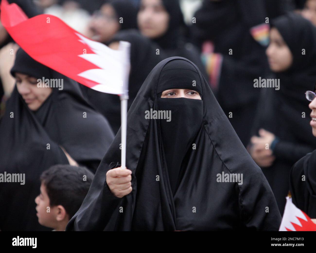 An unidentified Bahraini woman waves the national flag during an anti ...