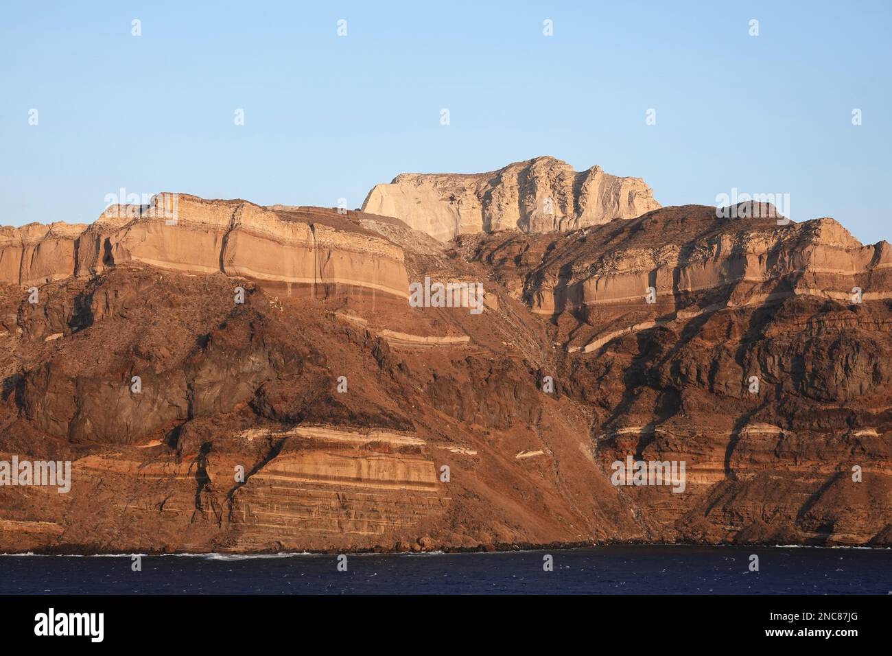 The cliffs revealing the geology of Santorini one of the Cyclades islands in the Aegean Sea, Greece Stock Photo
