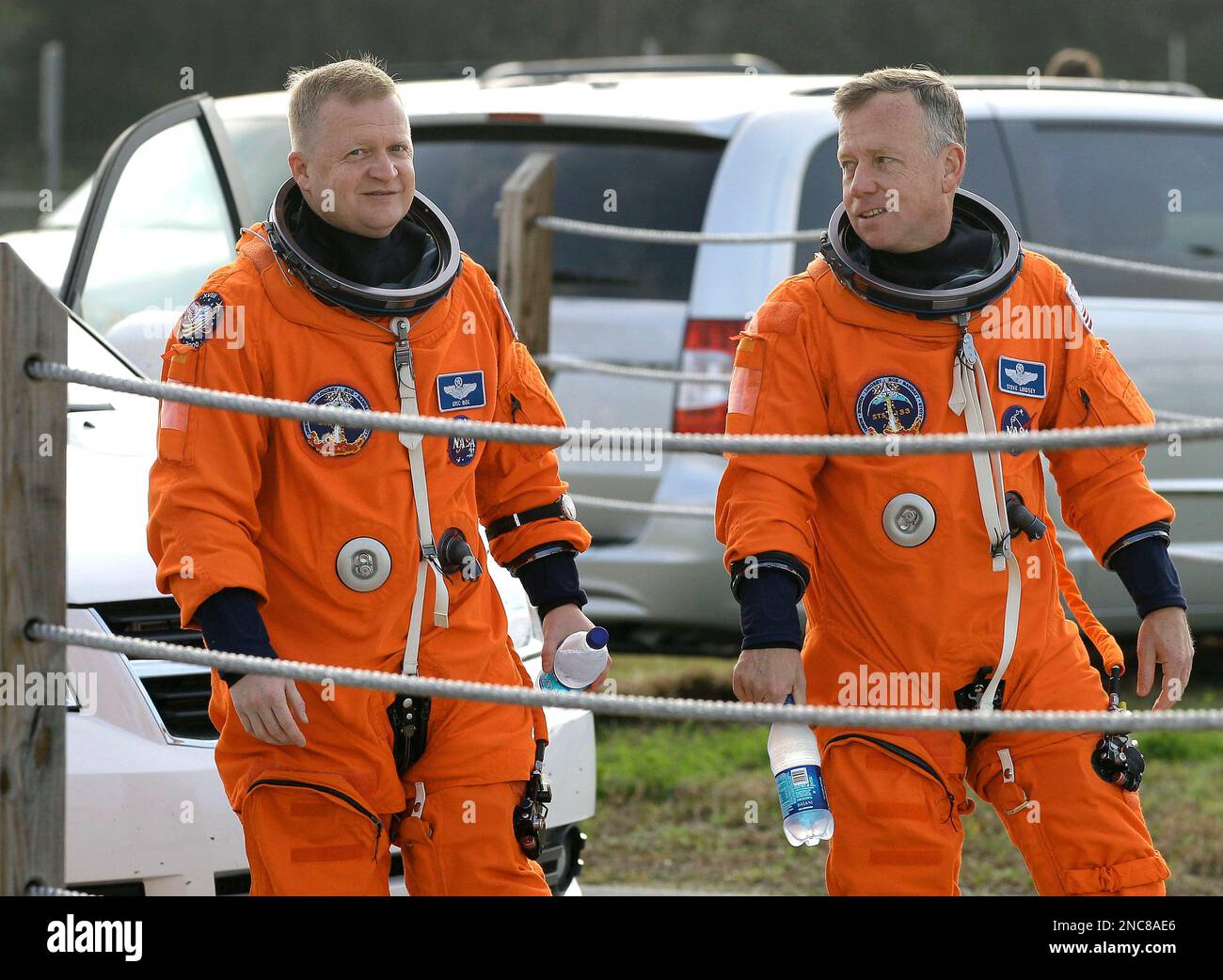 STS133 pilot Eric Boe, left, and commander Steve Lindsey walk acoss