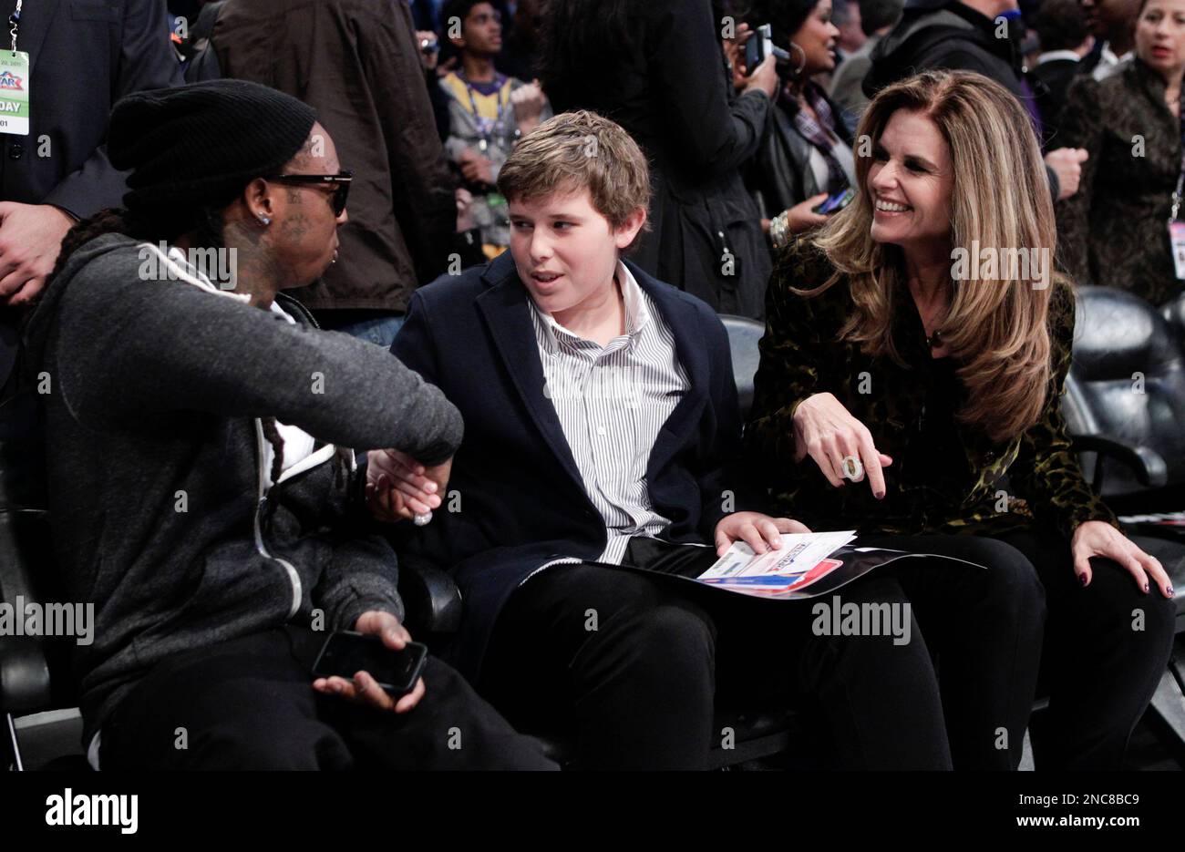 Rapper Lil Wayne, left, greets Christopher Schwarzenegger, center, as