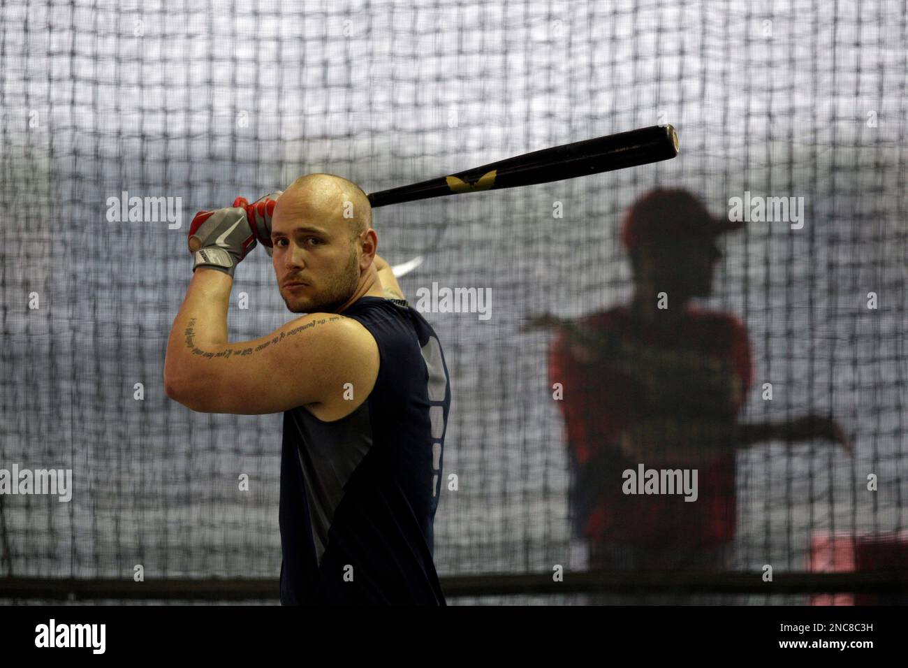 St. Louis Cardinals left fielder Matt Holliday works in the batting cage during spring training