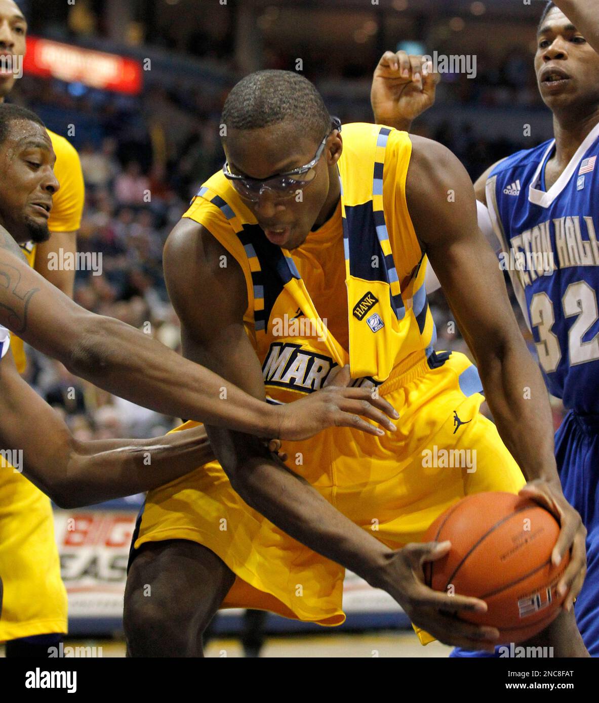 Seton Hall's Herb Pope, left, tugs at the jersey of Marquette's Chris