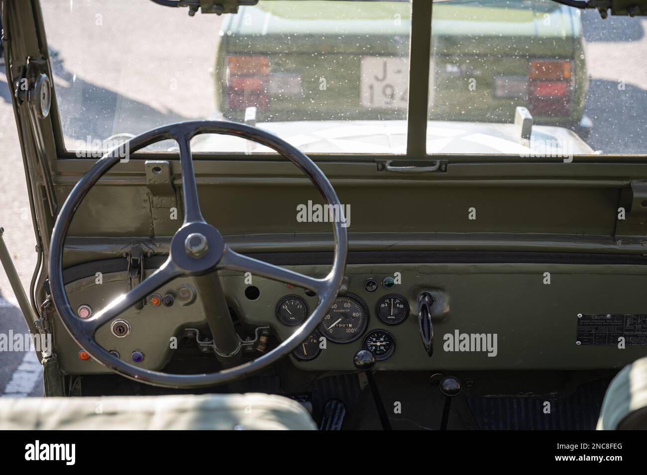 The steering wheel and controls of an old green Jeep Willys military SUV Stock Photo