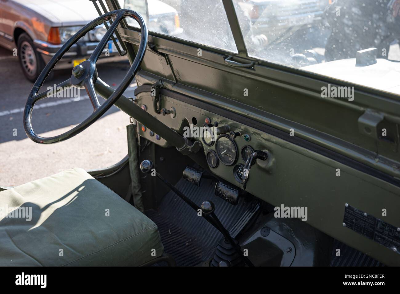 The steering wheel and controls of an old green Jeep Willys military SUV Stock Photo