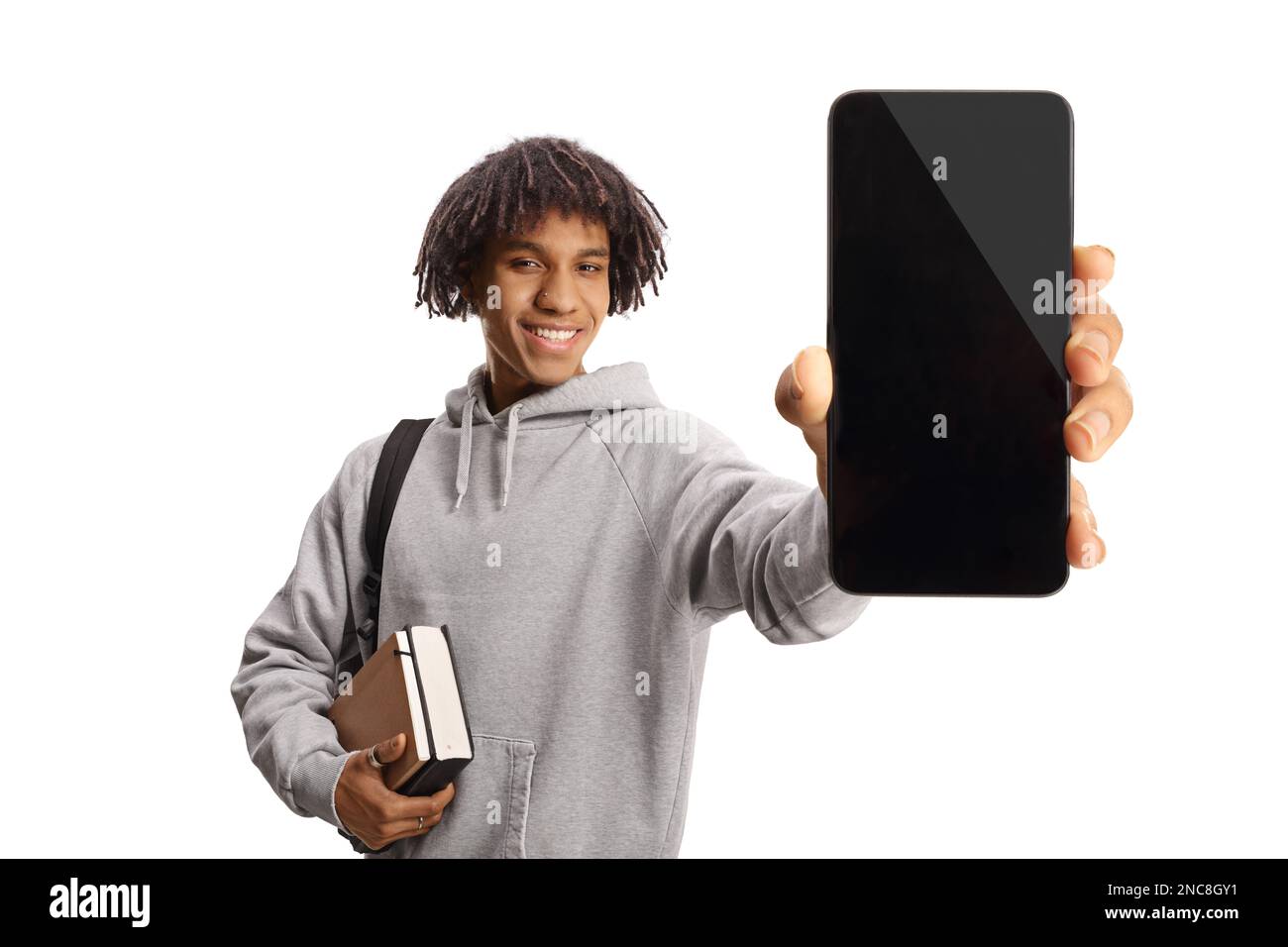 Young african american male student holding books and showing a mobile ...