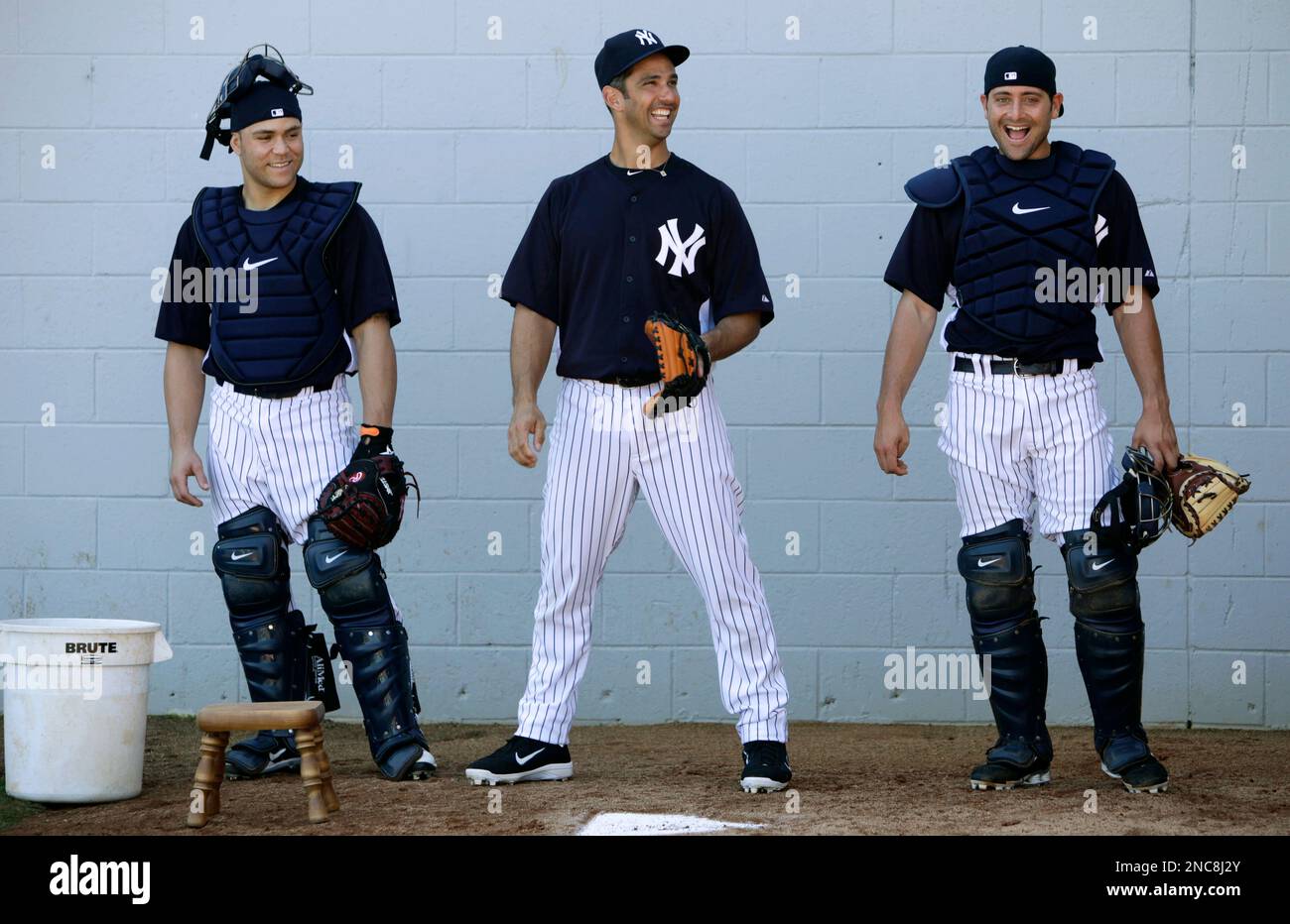 New York Yankees catchers Ivan Rodriguez, left, and Jorge Posada, right,  pose for a photo with Emilio Millito Navarro before Major League Baseball  action against the Chicago White Sox Thursday, Sept. 18