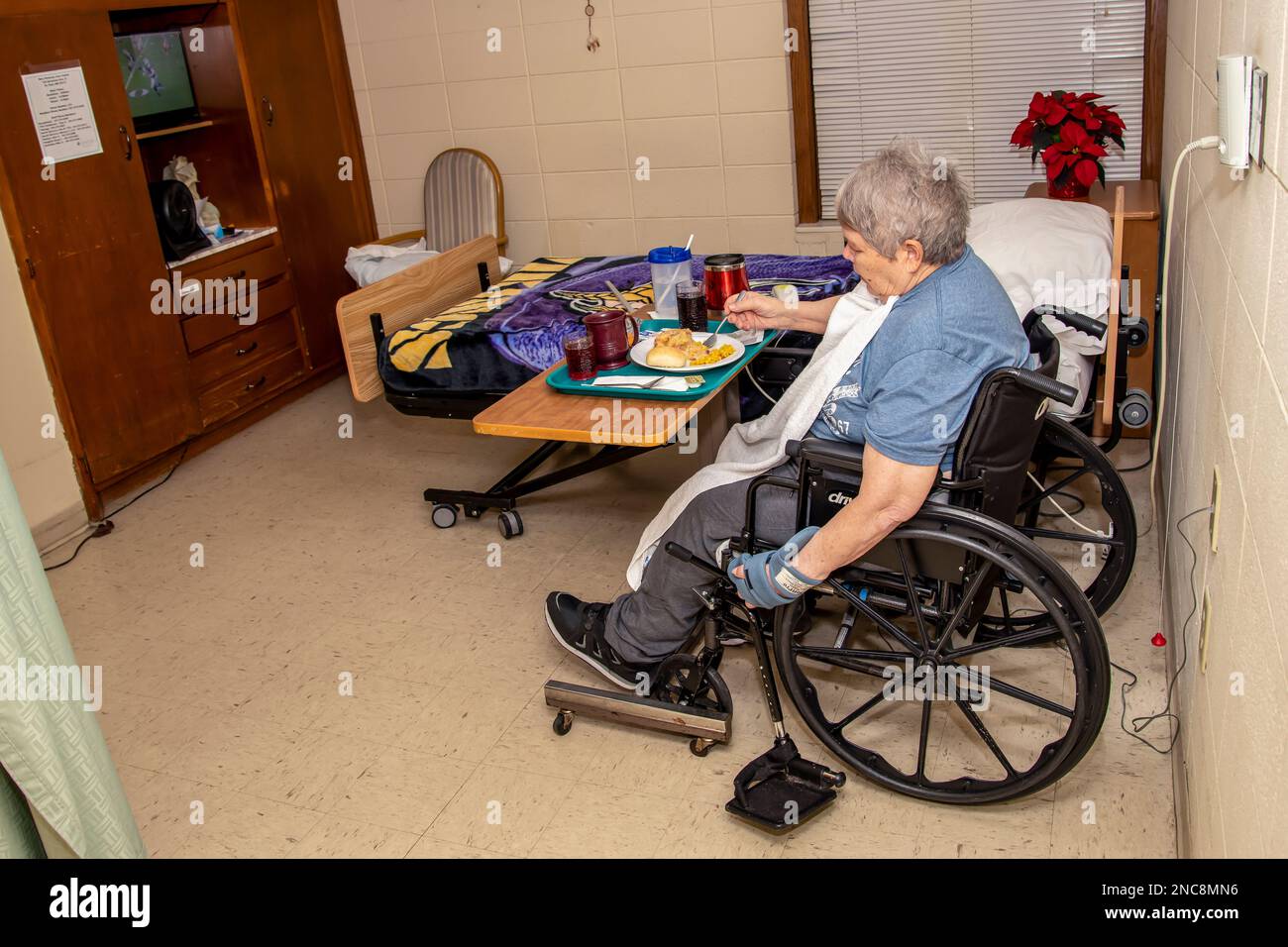 St. Paul, Minnesota.  73 year old woman enjoying a supper meal in a nursing home because of a stroke Stock Photo