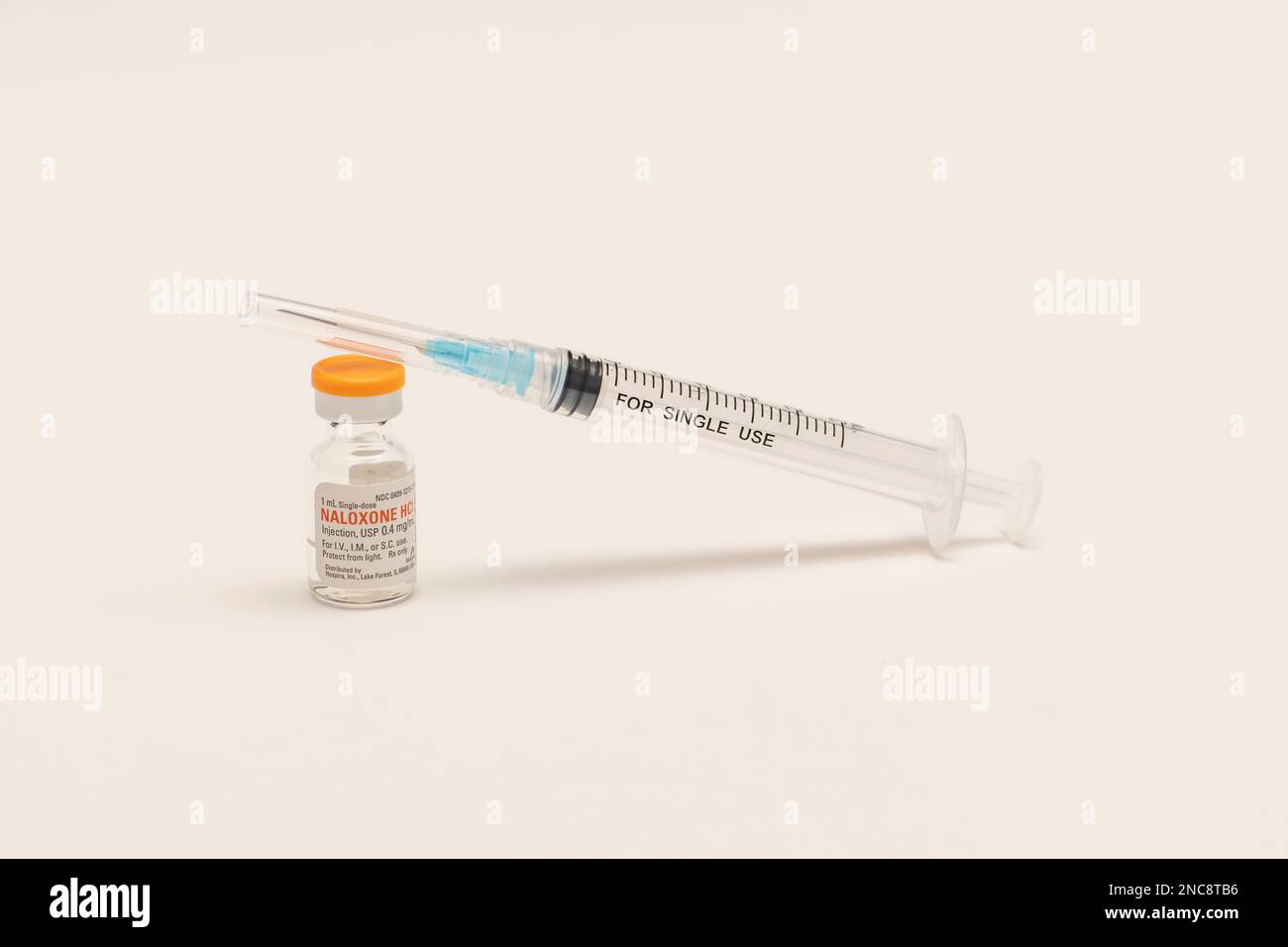 A bottle of Naloxone on white background with needle.  Naloxone is a life-saving medication that can reverse an overdose from opioids. Stock Photo