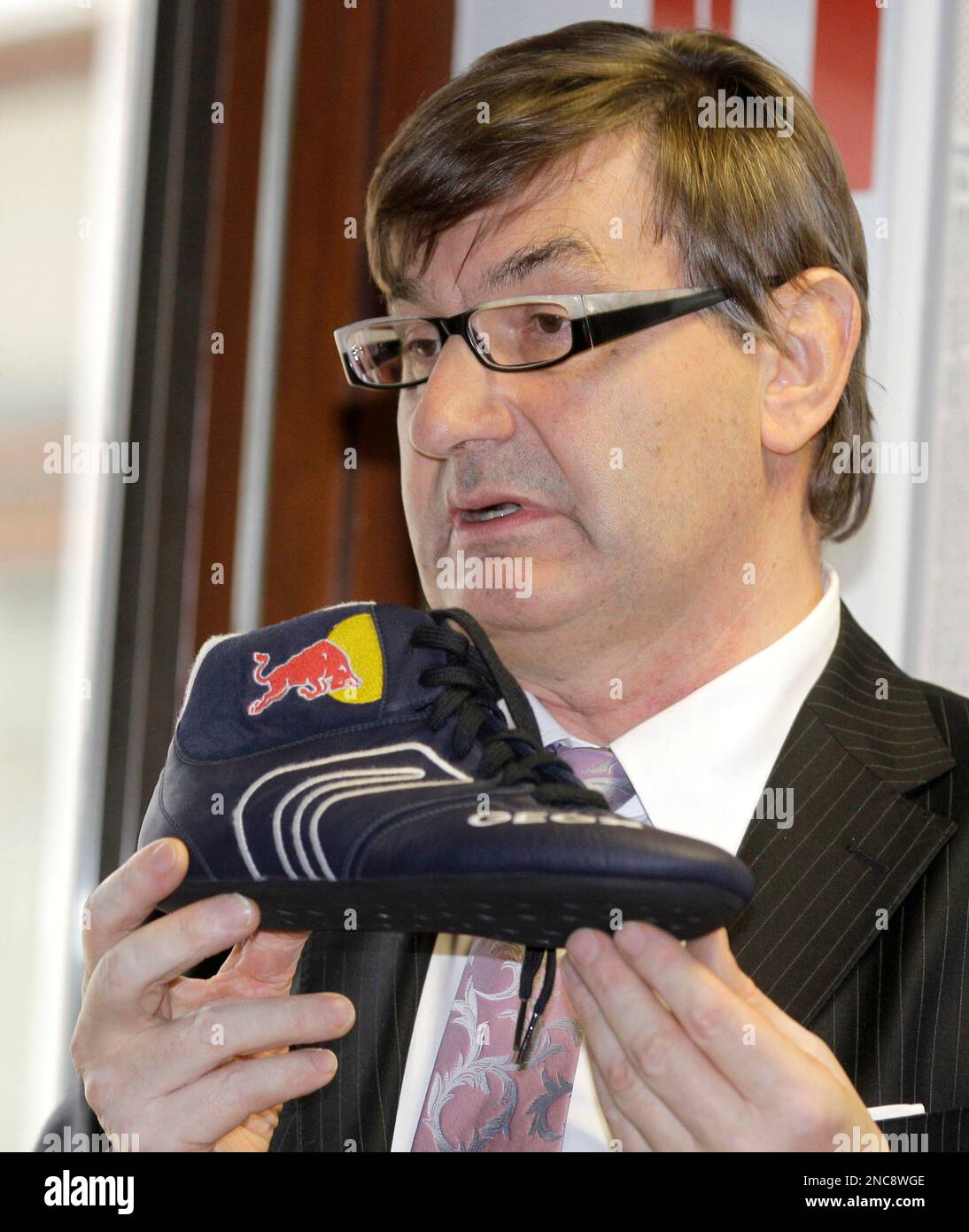 Geox President Mario Moretti Polegato shows a new Formula One Red Bull team  shoe during a news conference in Milan, Thursday, Feb. 17, 2011.(AP  Photo/Luca Bruno Stock Photo - Alamy