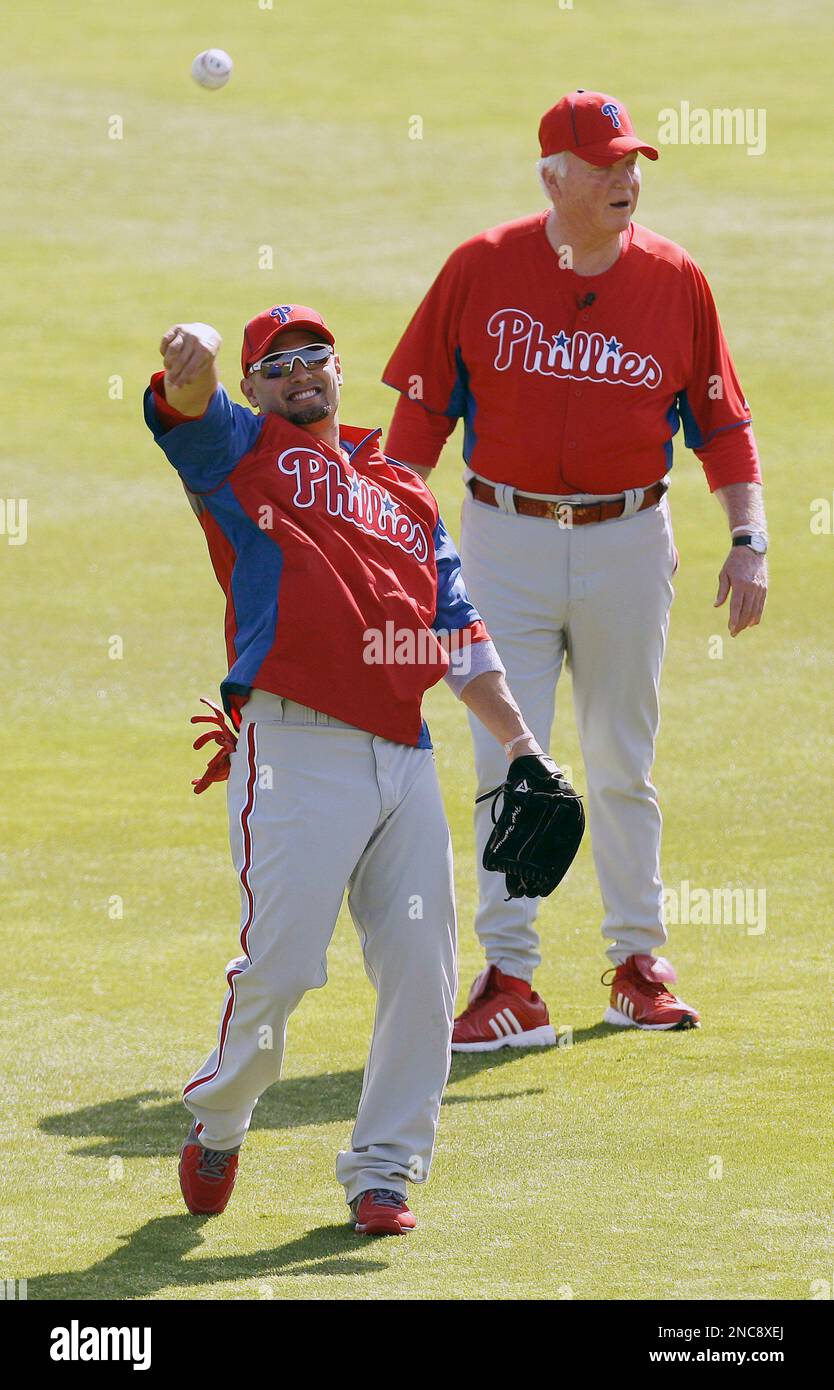 Philadelphia Phillies' Shane Victorino, left, throws as manager