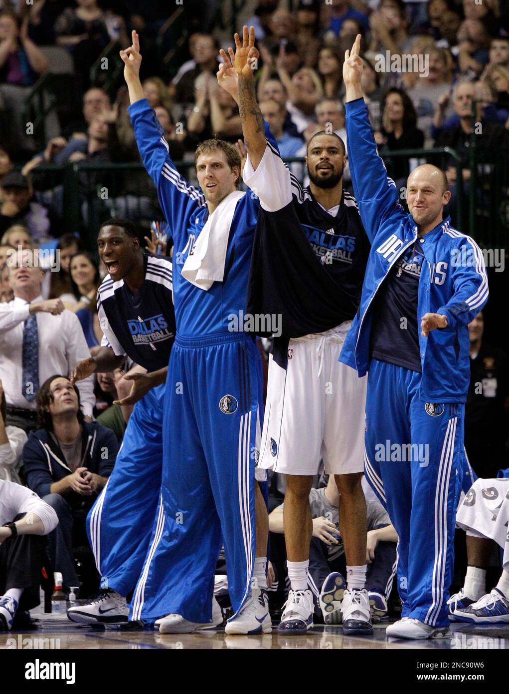 From front left to right, Dallas Mavericks' Ian Mahinmi, of France, Dirk  Nowitzki, of Germany, Tyson Chandler and Brian Cardinal celebrate following  a three-point basket by teammate Jason Kidd in the second