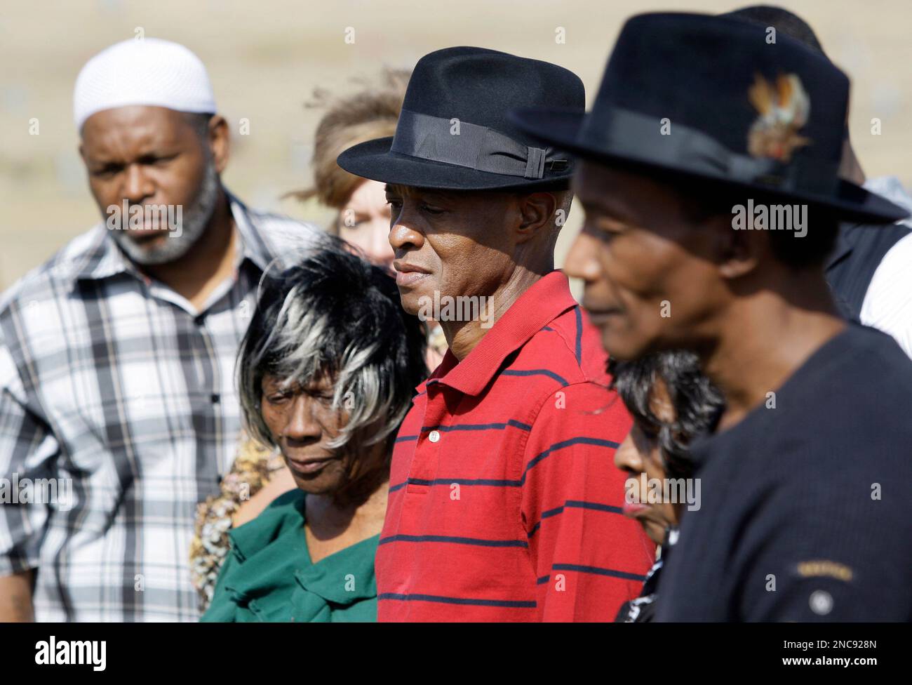 Larry Sims, center in red, is joined by DNA exonerees Billy Smith, left ...