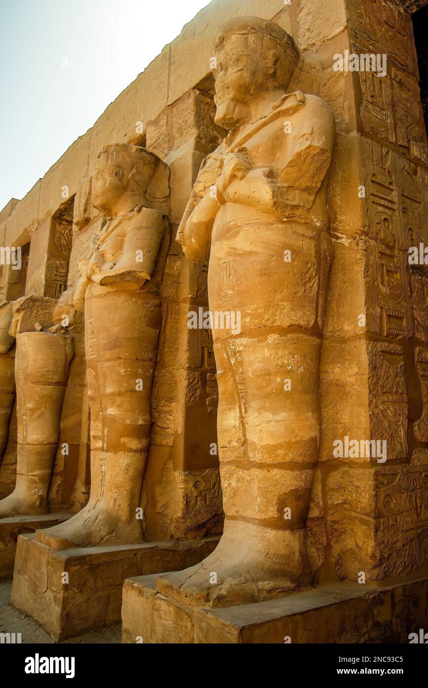 Luxor, Egypt. The Karnak Temple Complex, commonly known as Karnak, comprises a vast mix of decayed temples.In this image Statues of Ramses II as Osiris Stock Photo