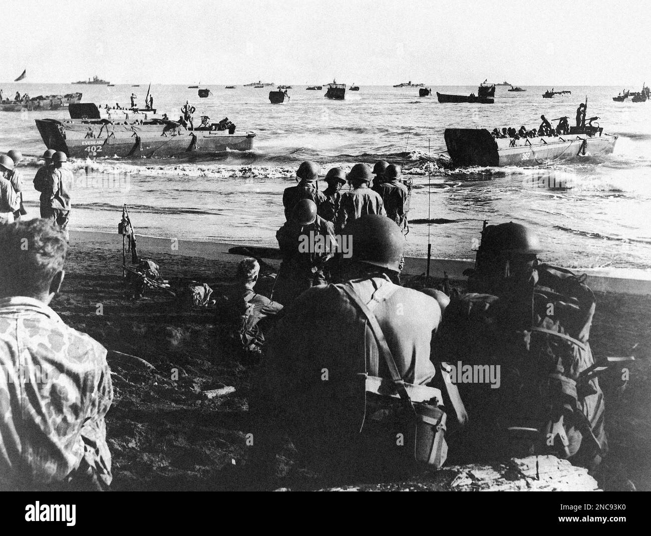 U.S. troops board a barge which will ferry them to a warship on June 5