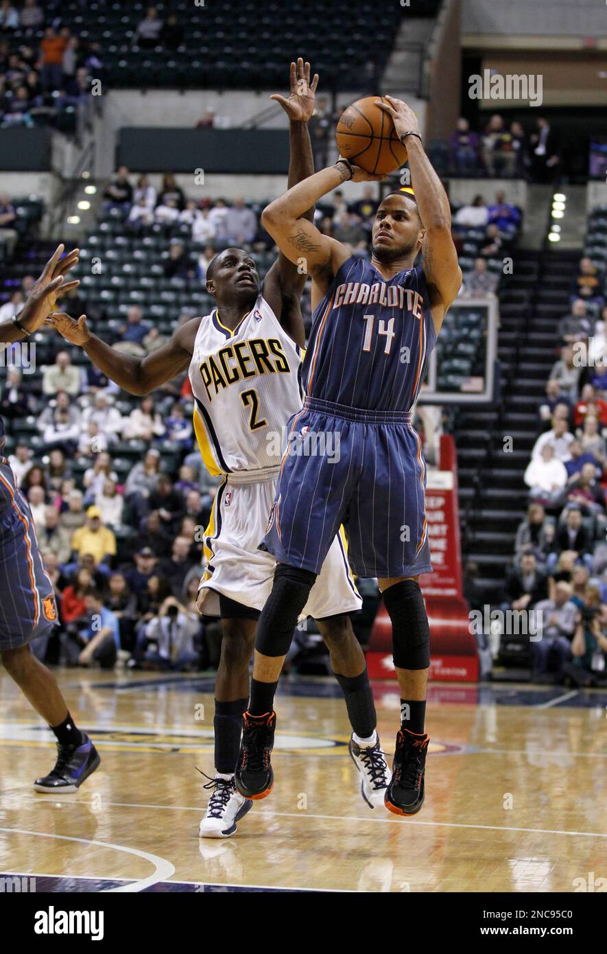 Charlotte Bobcats guard D.J. Augustin, right, shoots in front of ...