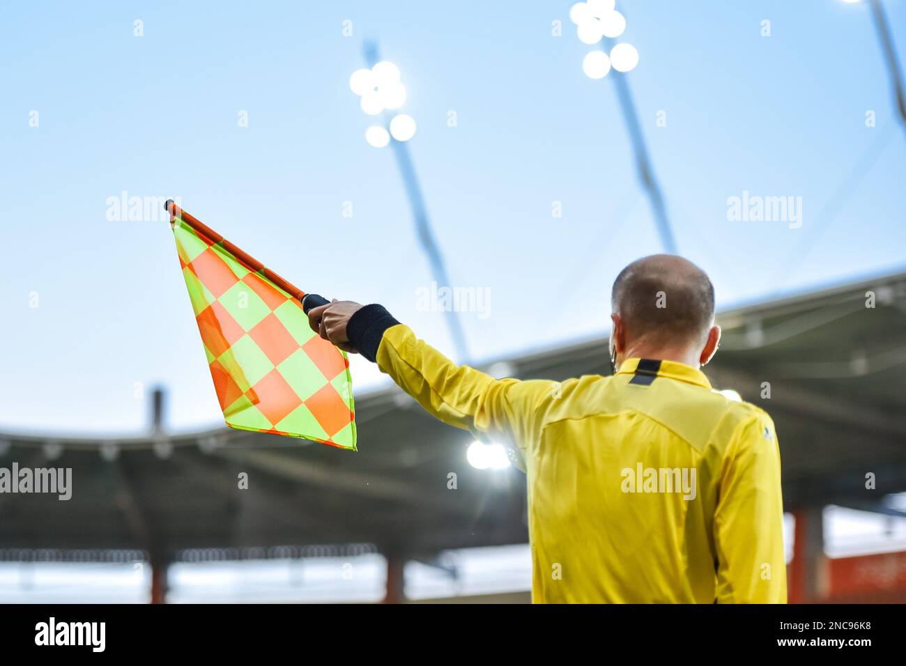 Sideline soccer fereree raise the flag up. Stock Photo