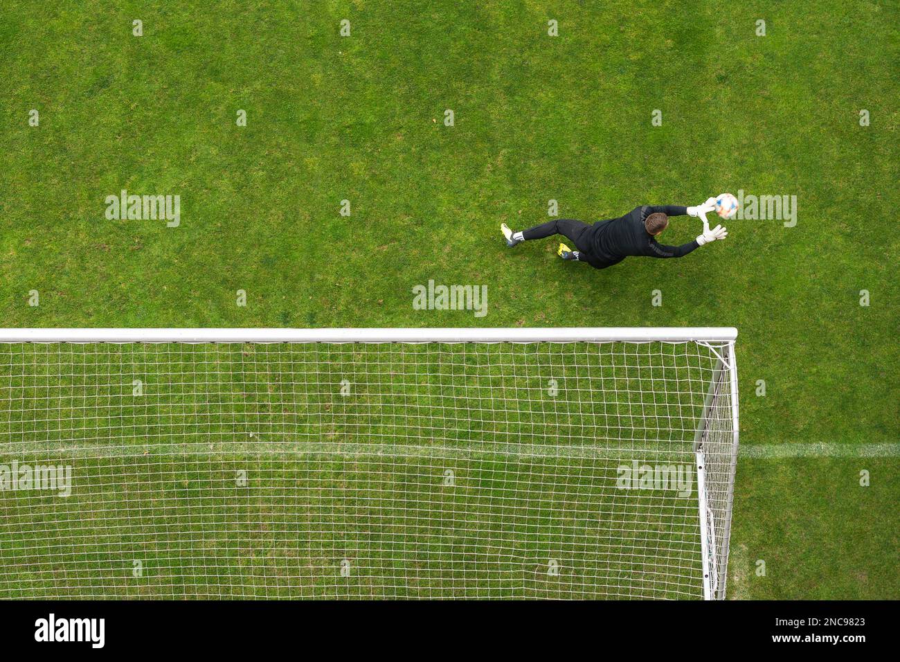 Soccer goalkeeper goalkeeper intervention view from above Stock Photo