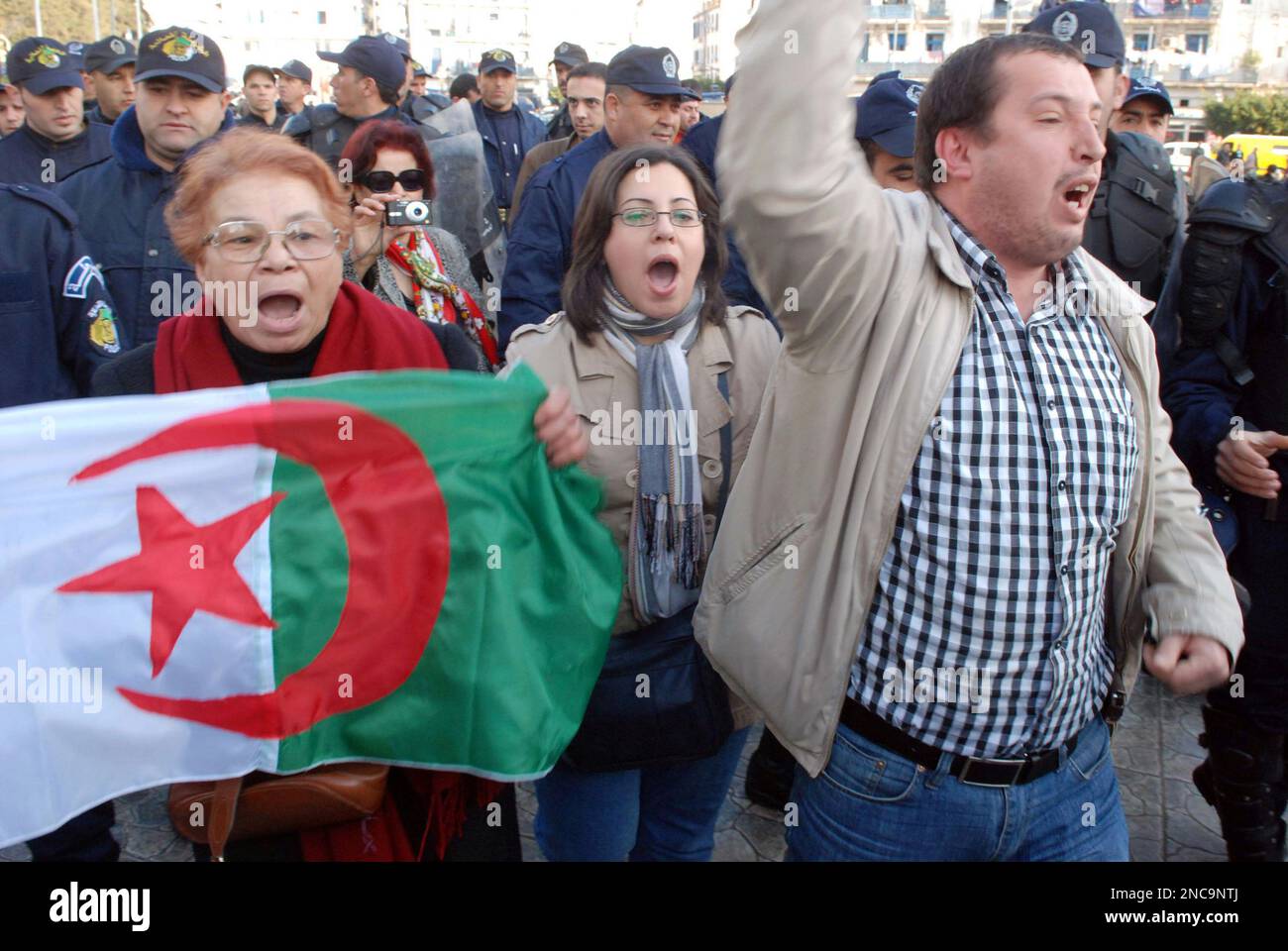 Algerian protesters holding their national flag chanted slogans