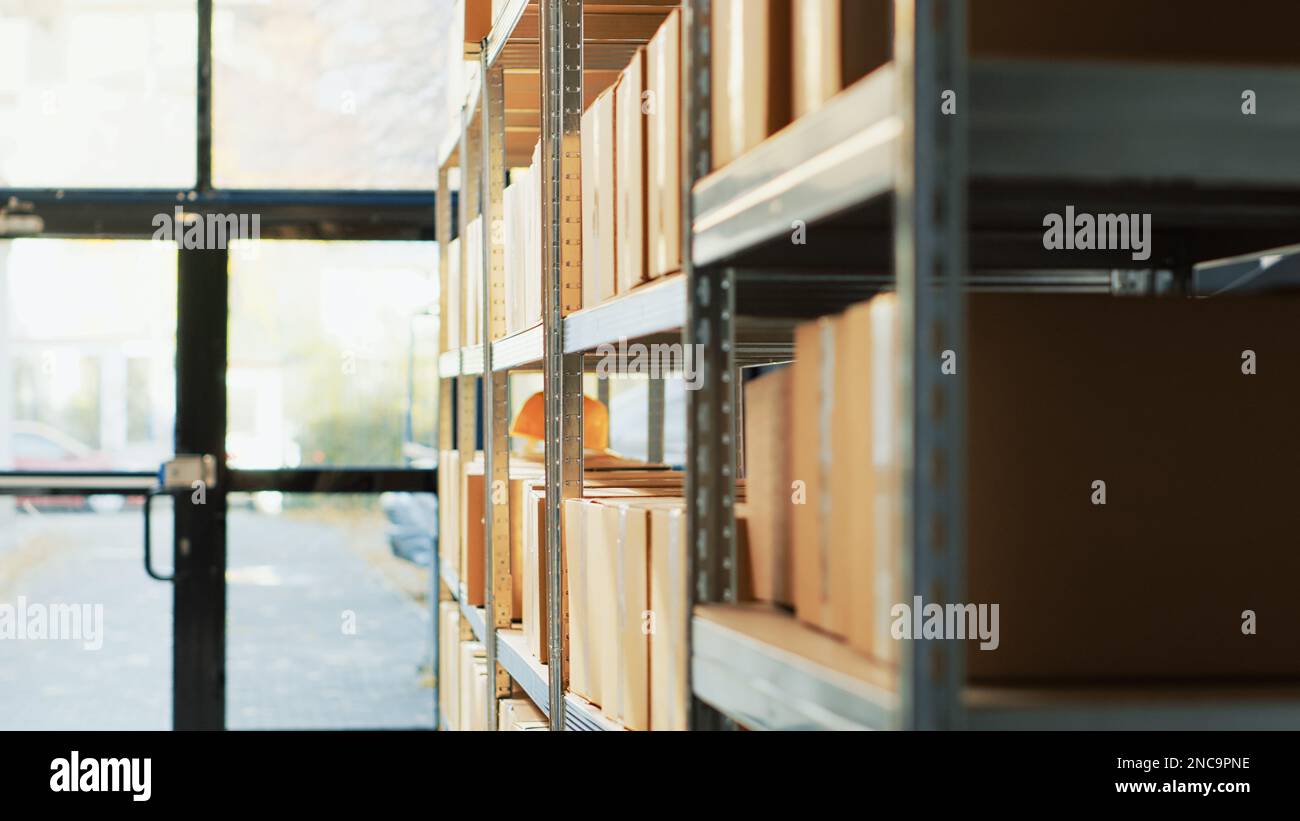 Empty storage room filled with cardboard boxes, shelves and racks with merchandise and cargo in