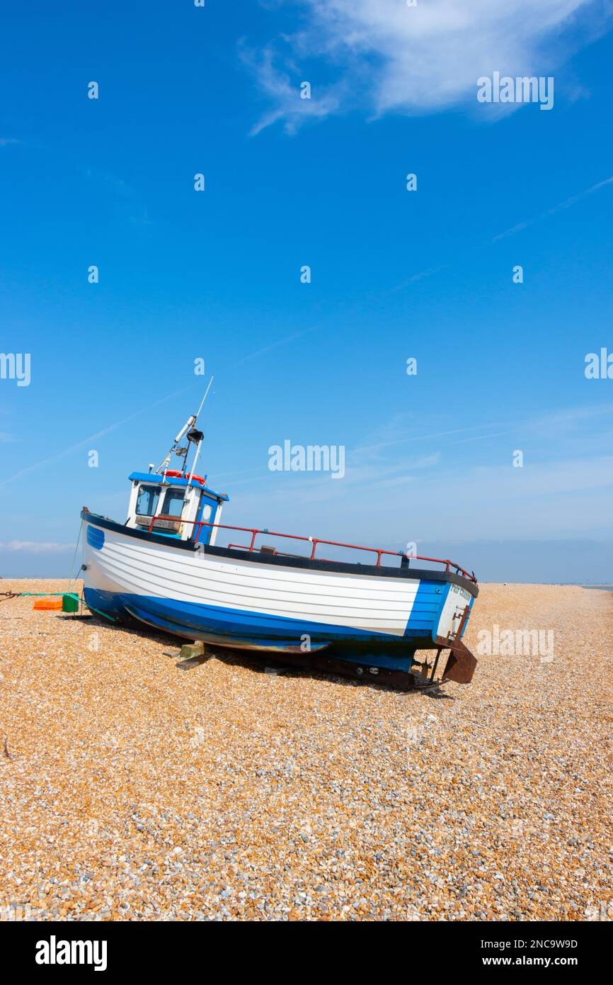 isolated wooden fishing boat on a shingle beach at Dungeness Kent Stock ...