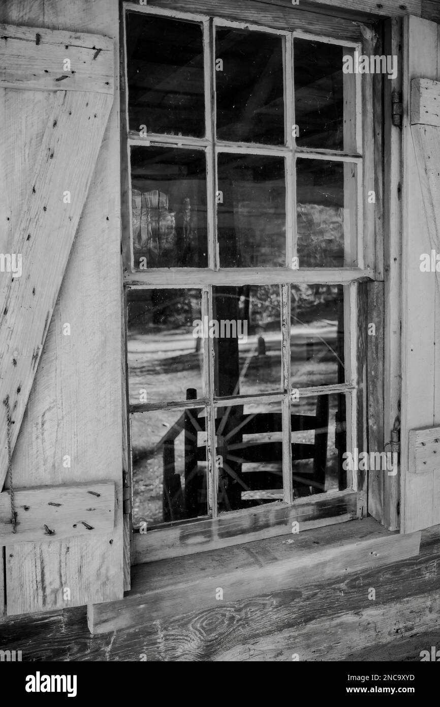 A closeup of windowpanes and shutters from civil war era 1800slog cabin ...