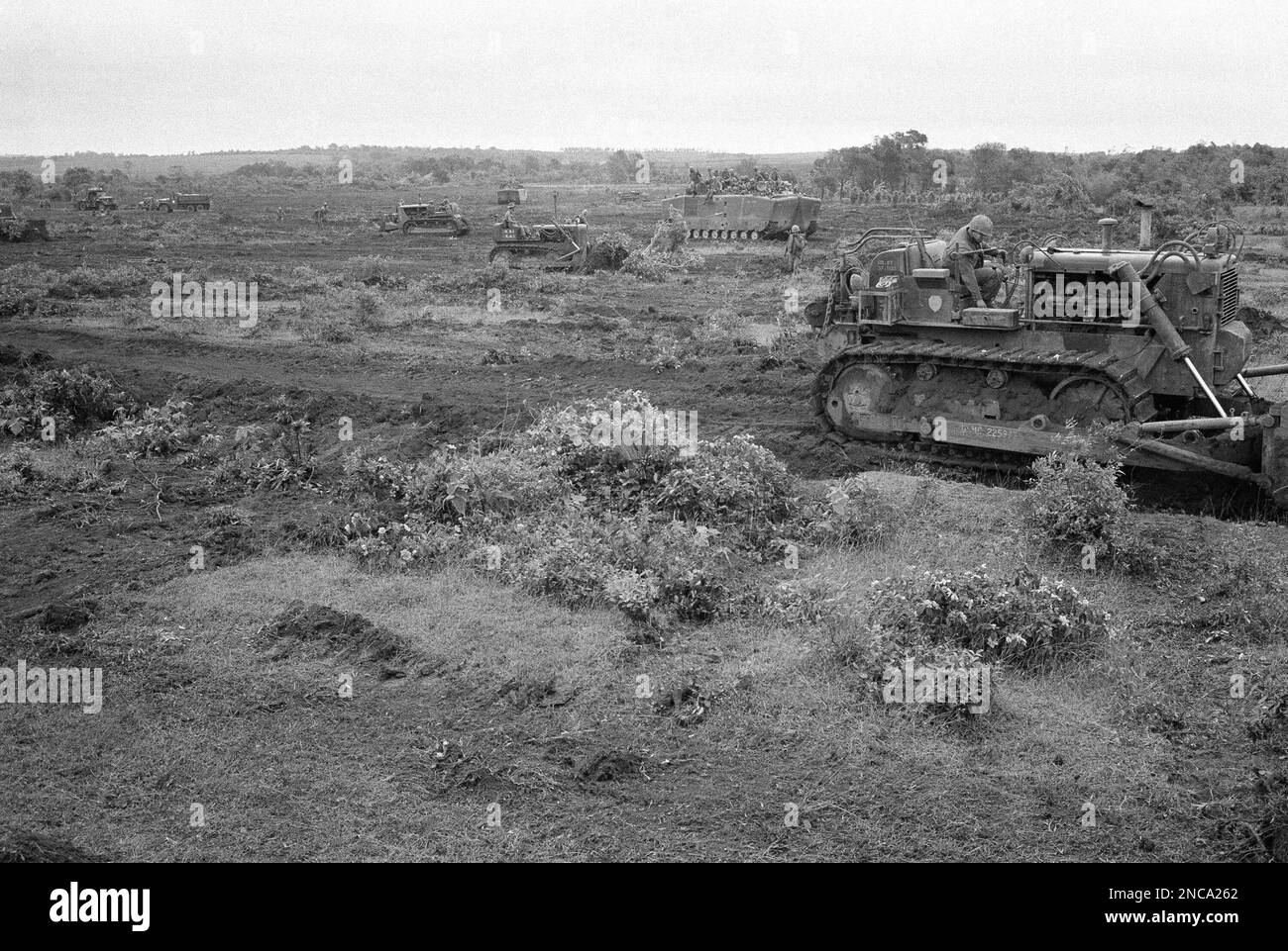Bulldozers manned by U.S. marines and South Vietnamese soldiers clear