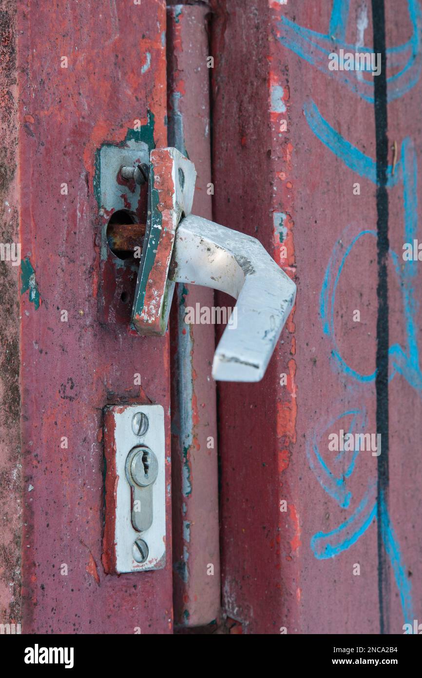 Door handle ripped out by force on a steel gate. Stock Photo