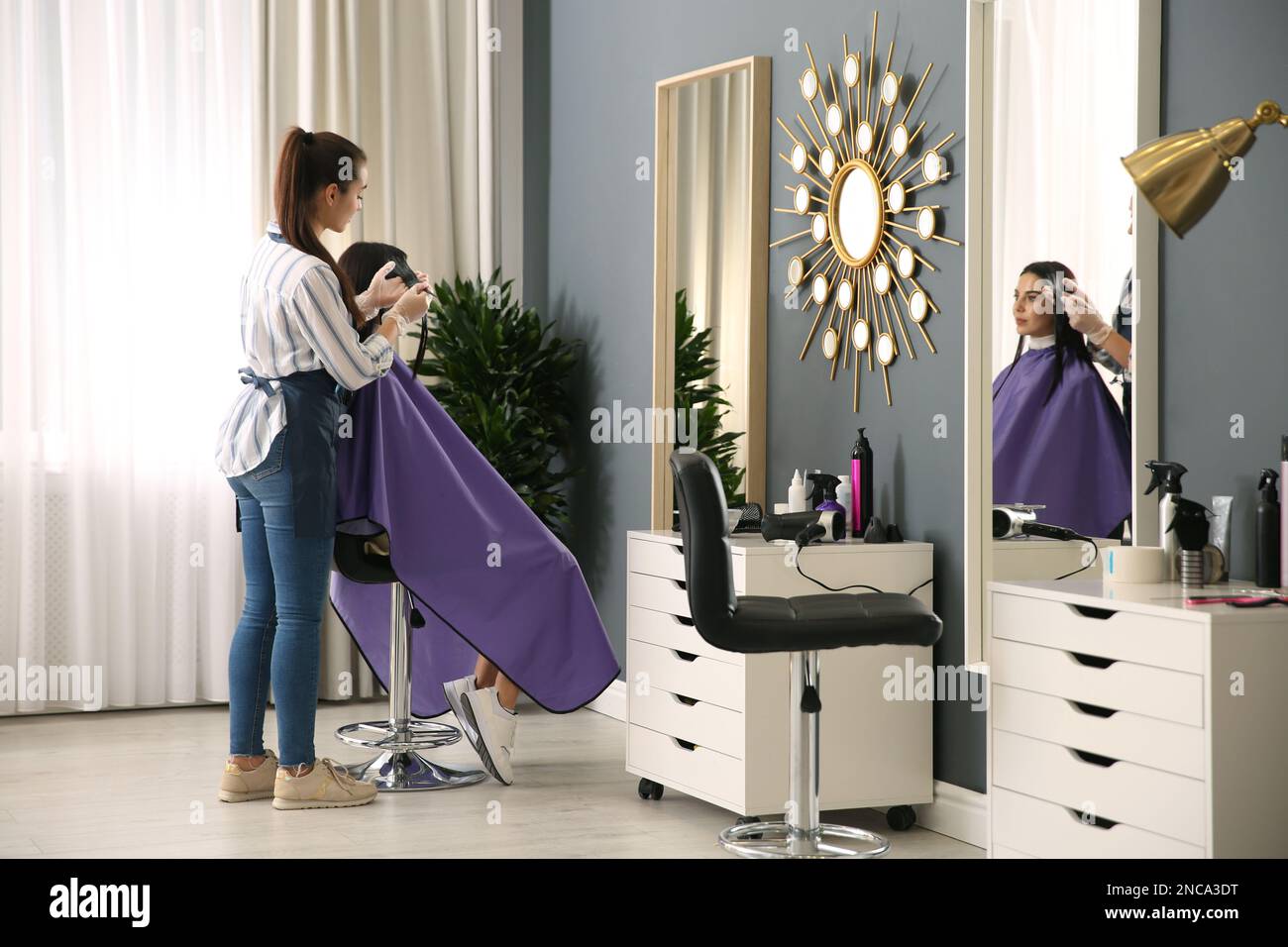 Professional hairdresser dying hair in beauty salon Stock Photo Alamy