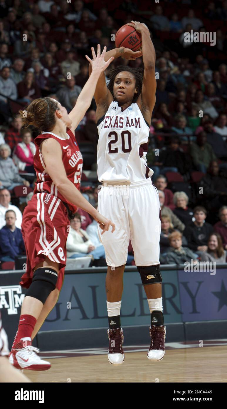 Texas A&M's Tyra White (20) shoots over Oklahoma's Whitney Hand (25) in