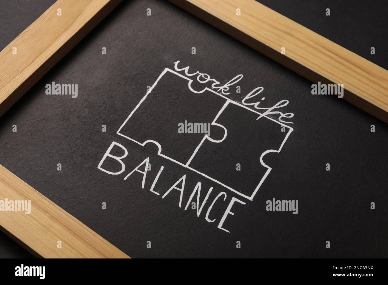Drawing of puzzles and words Work, Life, Balance on blackboard, closeup ...