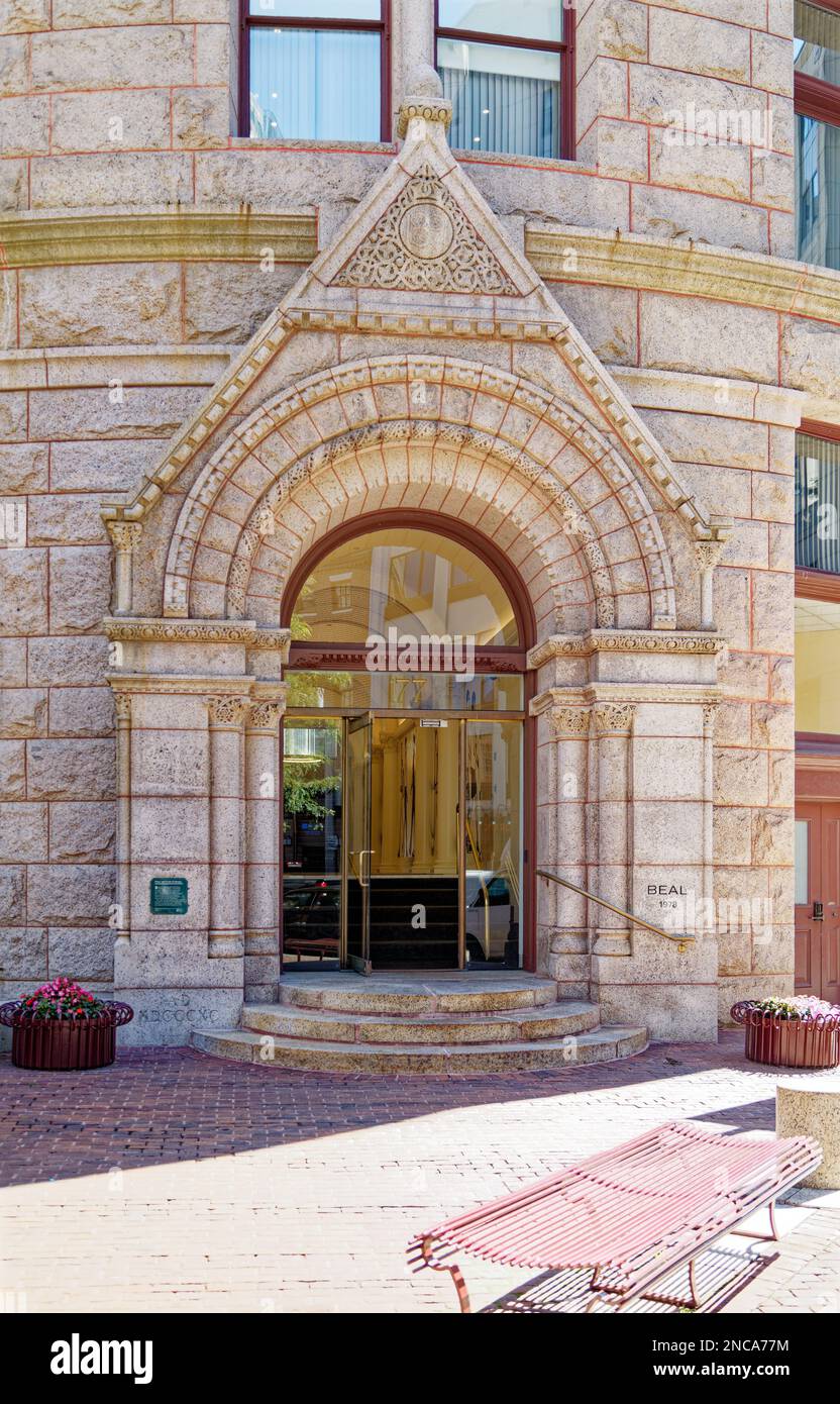 Boston landmark Grain Exchange Building opened in 1893. The former Chamber of Commerce Building has a pink granite façade, with Romanesque styling. Stock Photo