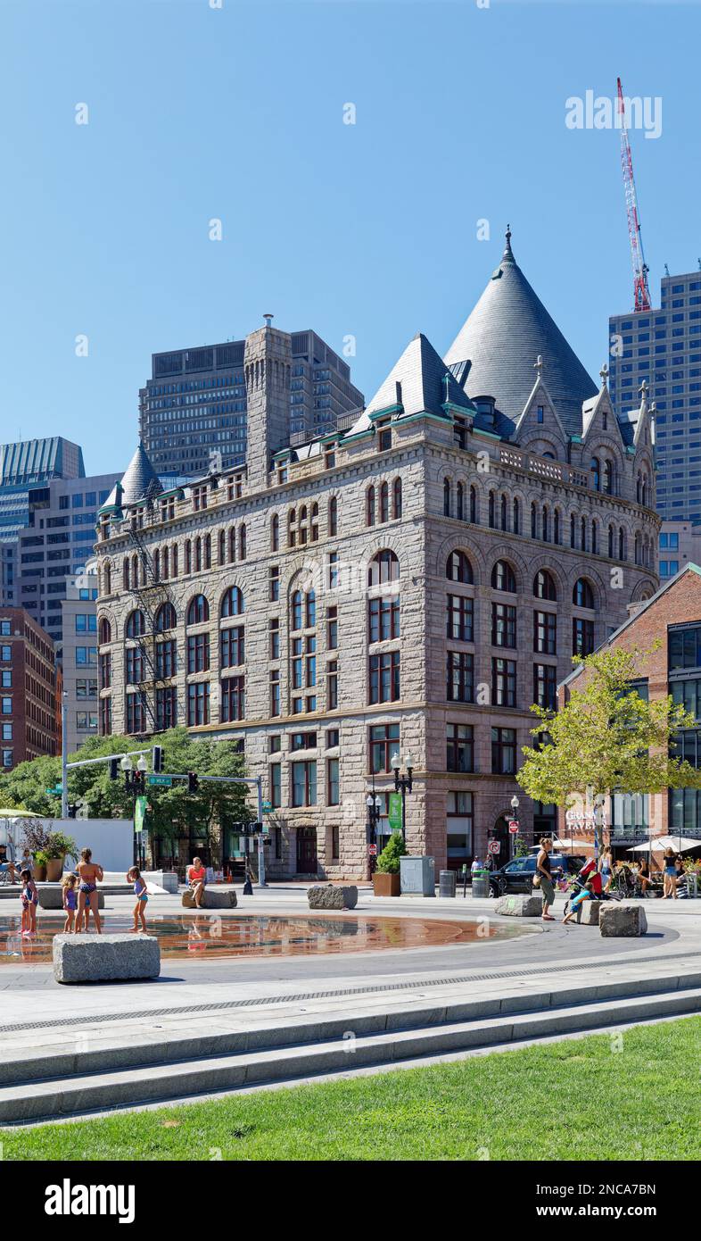 Boston landmark Grain Exchange Building opened in 1893. The former Chamber of Commerce Building has a pink granite façade, with Romanesque styling. Stock Photo