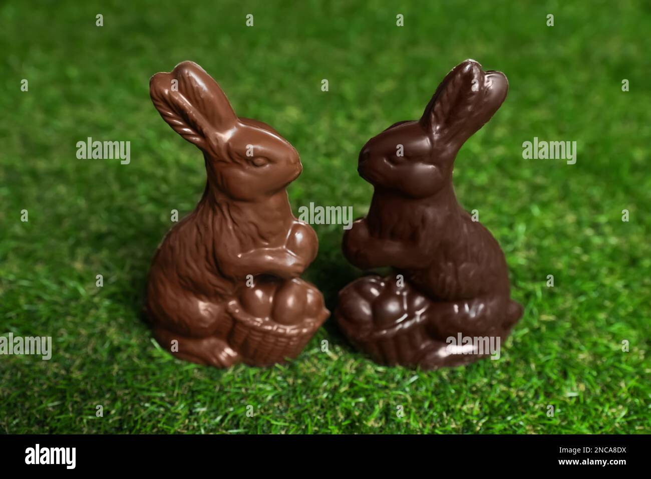 Chocolate bunnies on green grass. Easter celebration Stock Photo