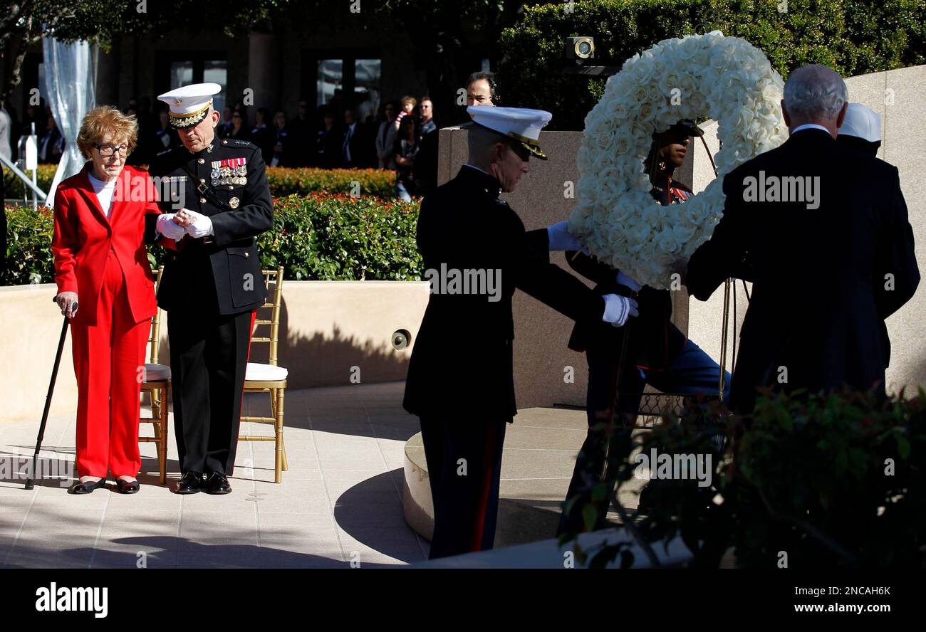 Former first lady Nancy Reagan is helped by Marine Lt. Gen. George J ...
