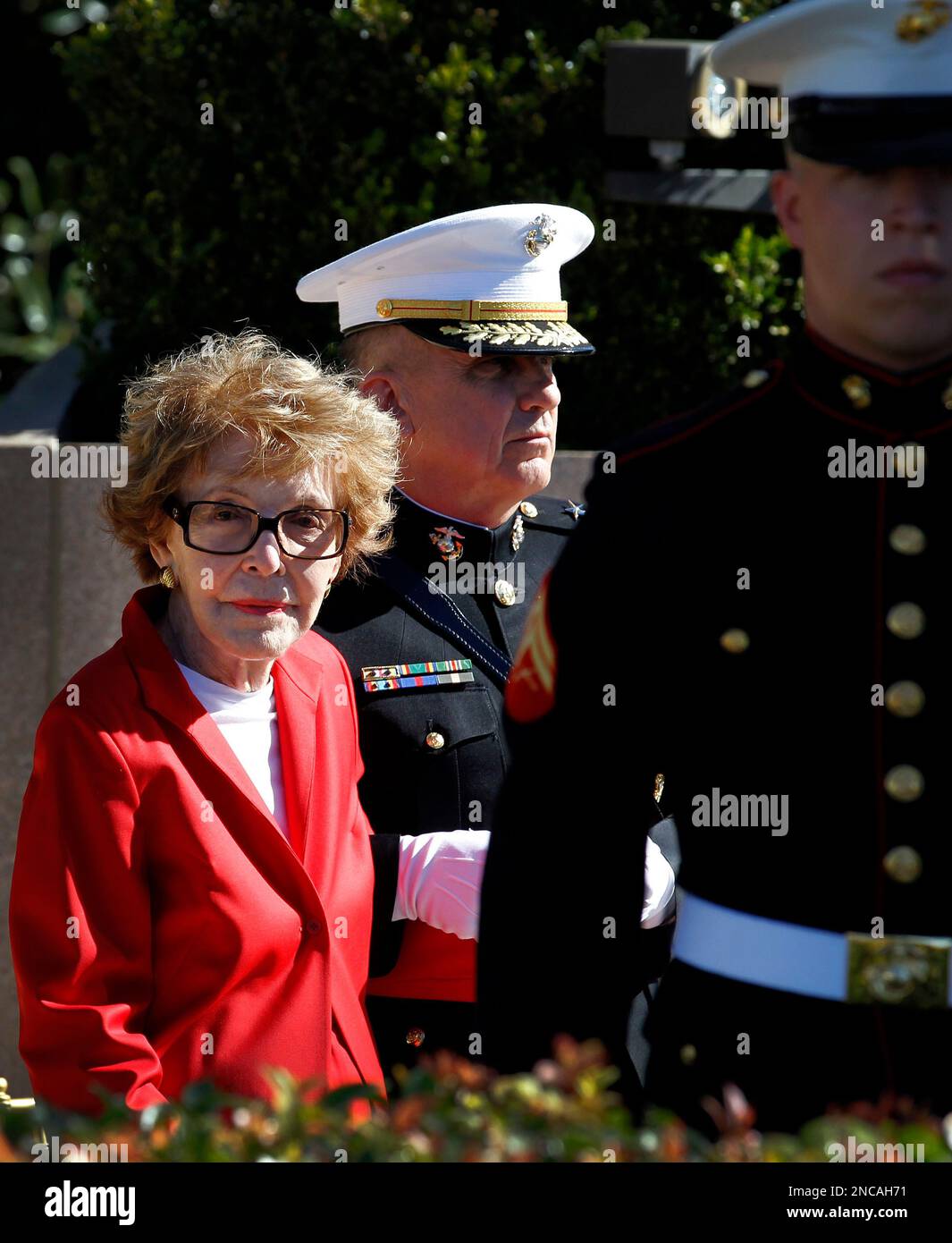 Former first lady Nancy Reagan is helped by Marine Lt. Gen. George J ...
