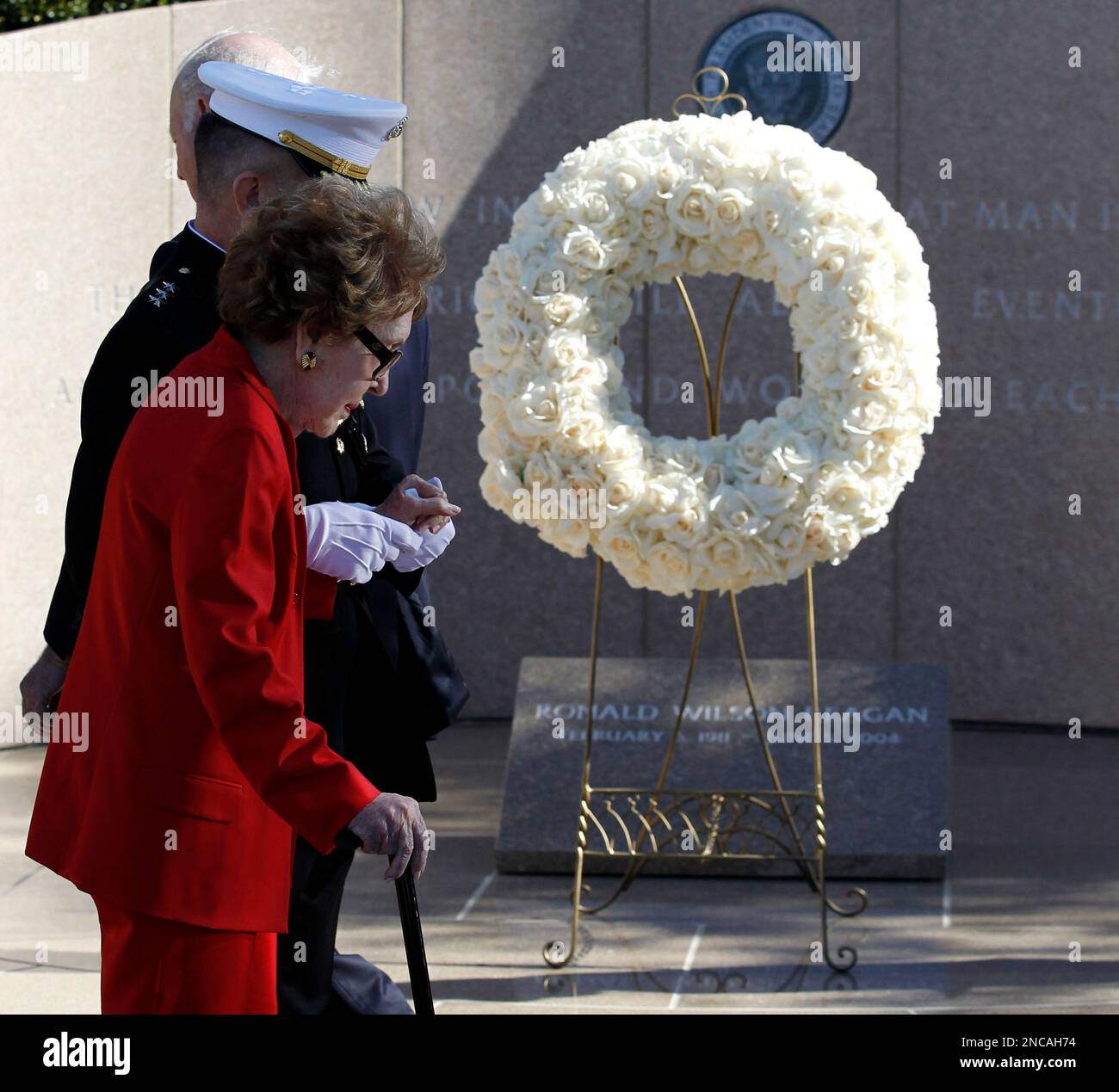 Former first lady Nancy Reagan is helped by Marine Lt. Gen. George J ...