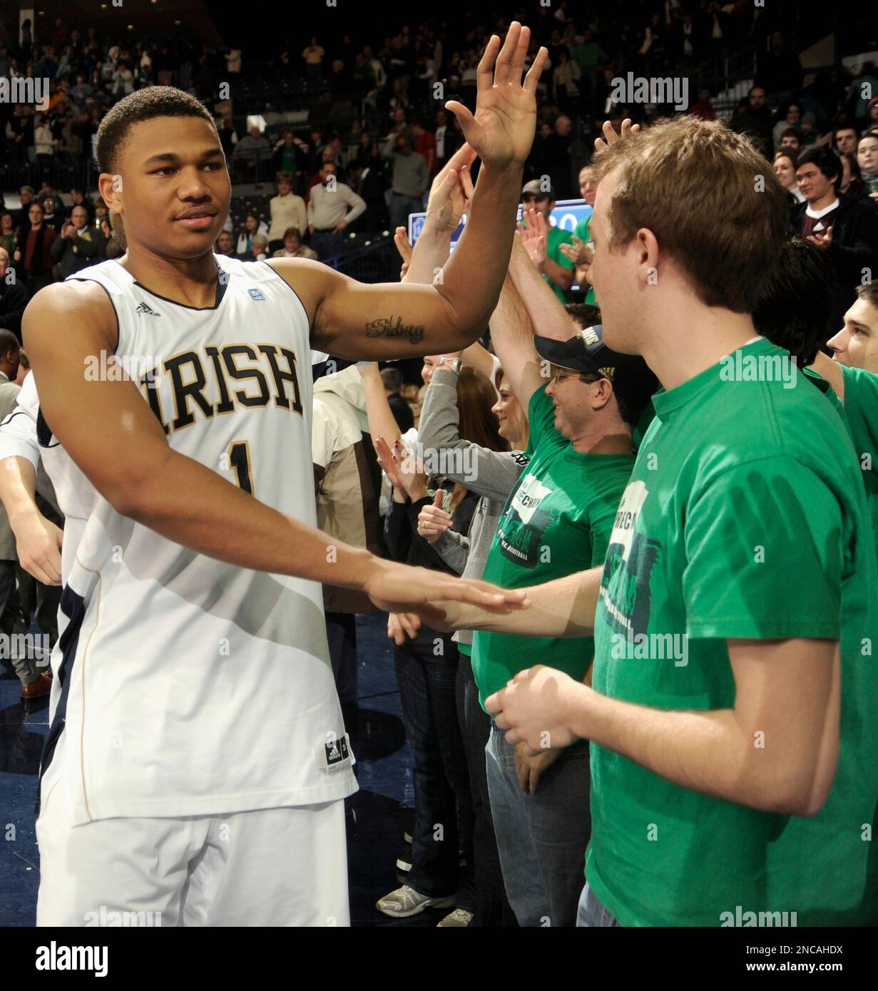 Notre Dame forward Tyrone Nash, left, celebrates with students