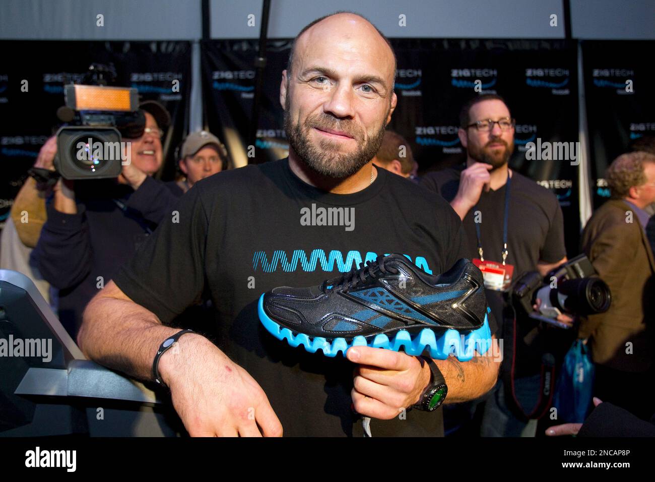 Randy Couture holds a Reebok ZigTech footwear during the Reebok "ZigTech  Cowboy Up Challenge" in Dallas on February 4, 2011 where top athletes and  celebrities showed the media the power of ZigTech