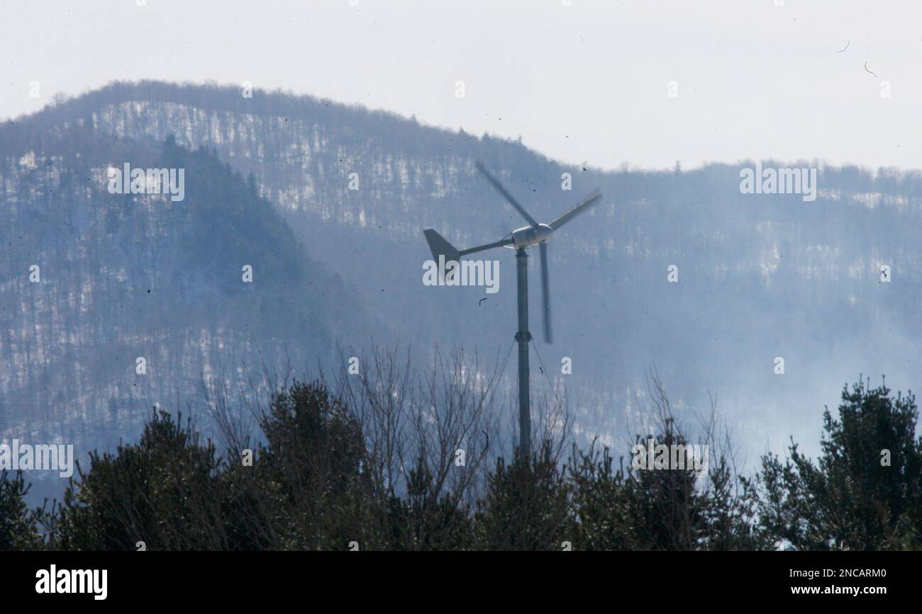 FILE In this March 5, 2010 file photo, a windmill is seen with Lowell Mountain in the