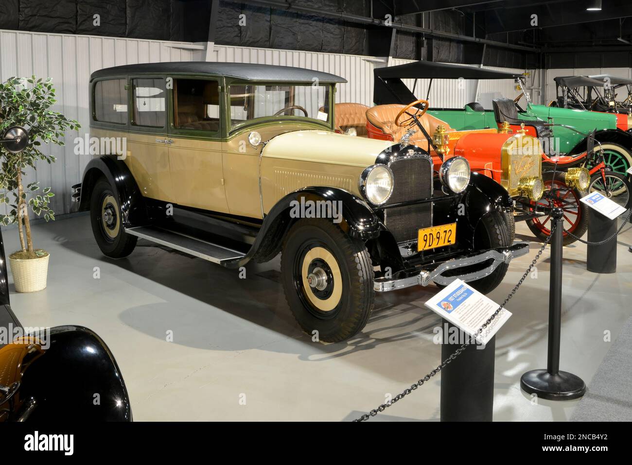 A yellow and green 1927 Studebaker President Big Six four-door sedan is at the Northeast Classic Car Museum in Norwich, New York. Stock Photo