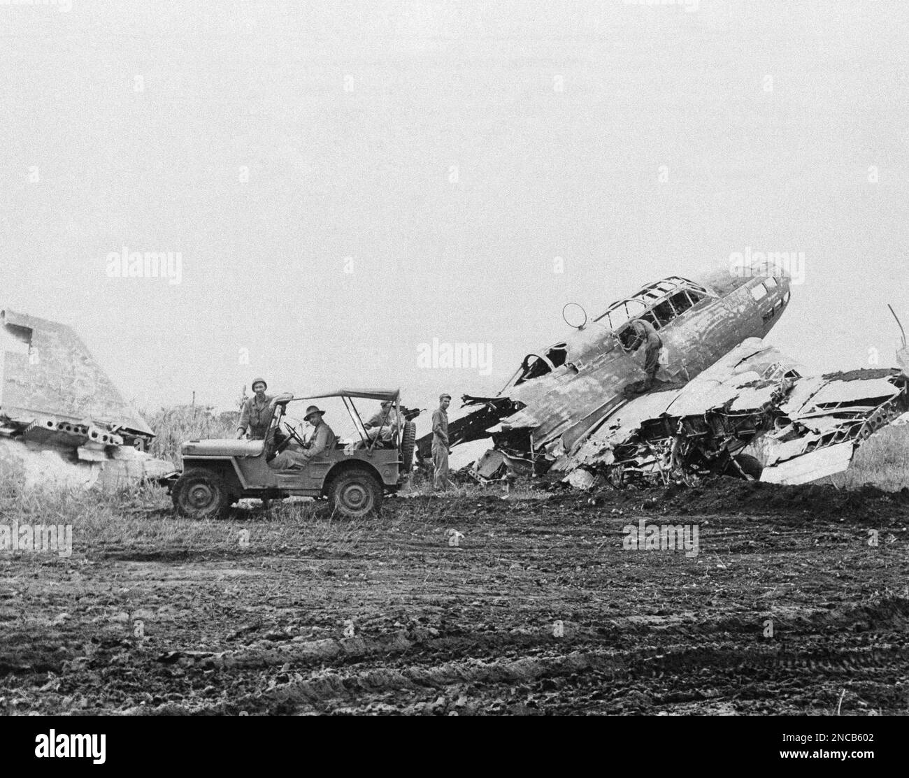 U.S. and Australian soldiers inspect the wreckage of a Japanese bomber, at Lae, Papua New Guinea on Sept. 30, 1943, in the Allied offensive which led to the capture of the base on September 16. (AP Photo) Stock Photo