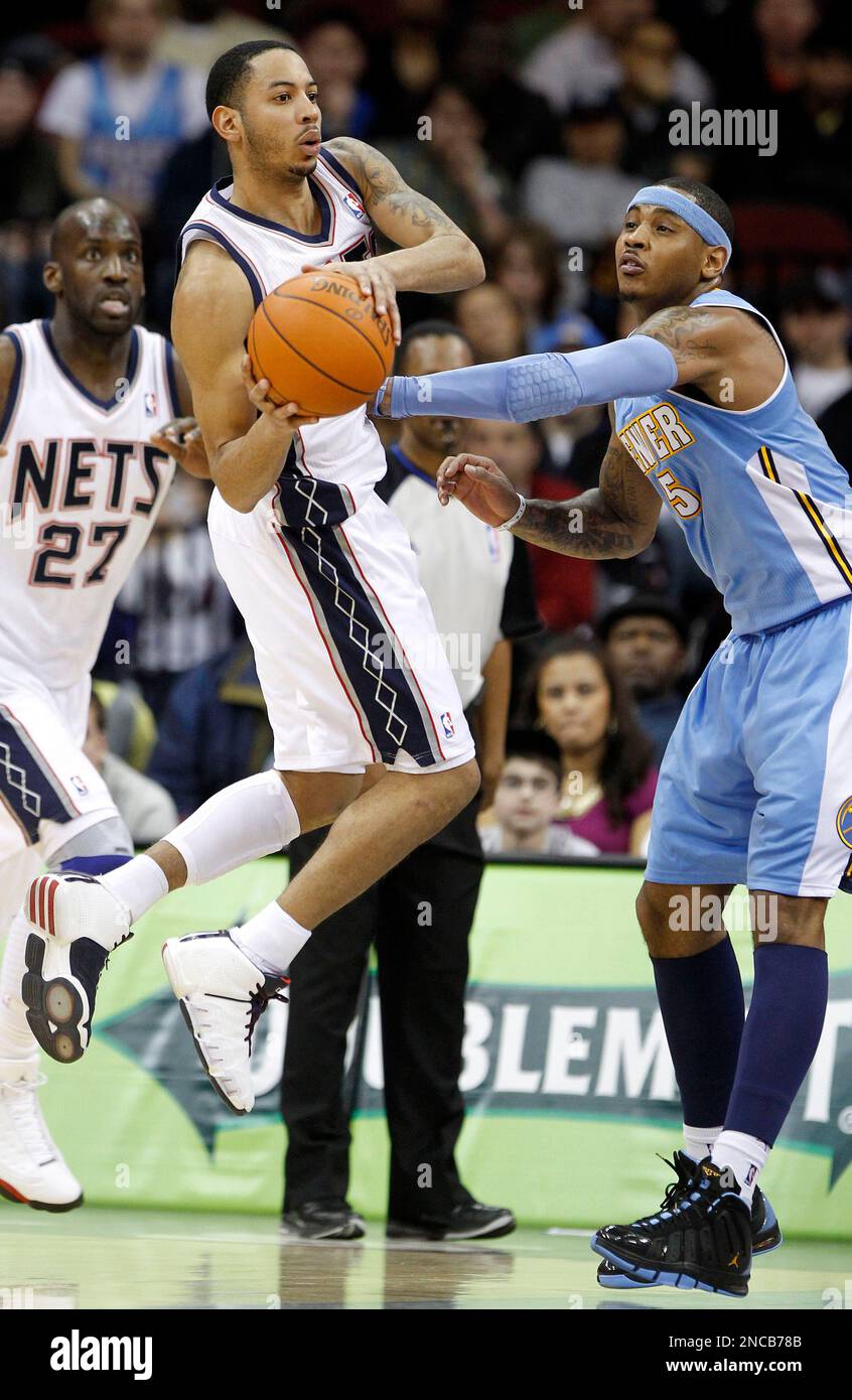 New Jersey Nets point guard Devin Harris, left, looks to pass as Denver
