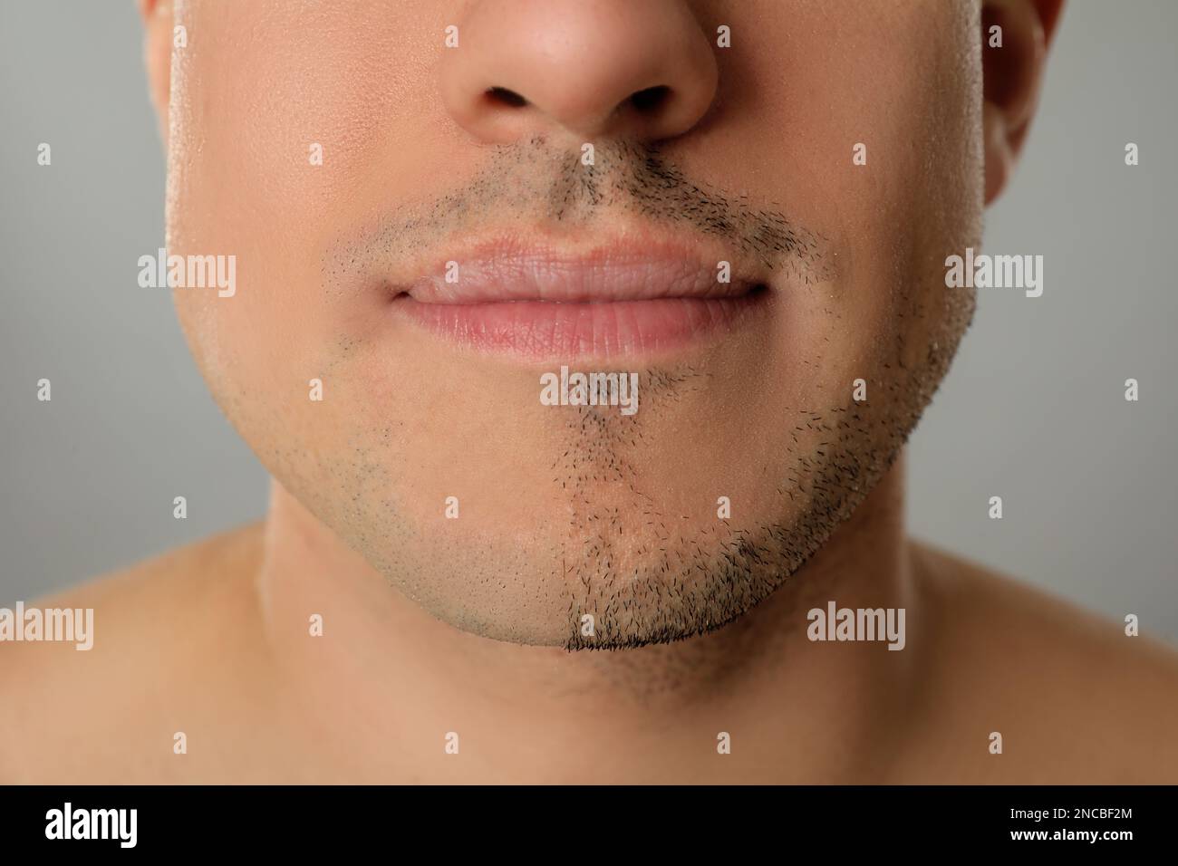 Man with half shaved face on grey background, closeup Stock Photo