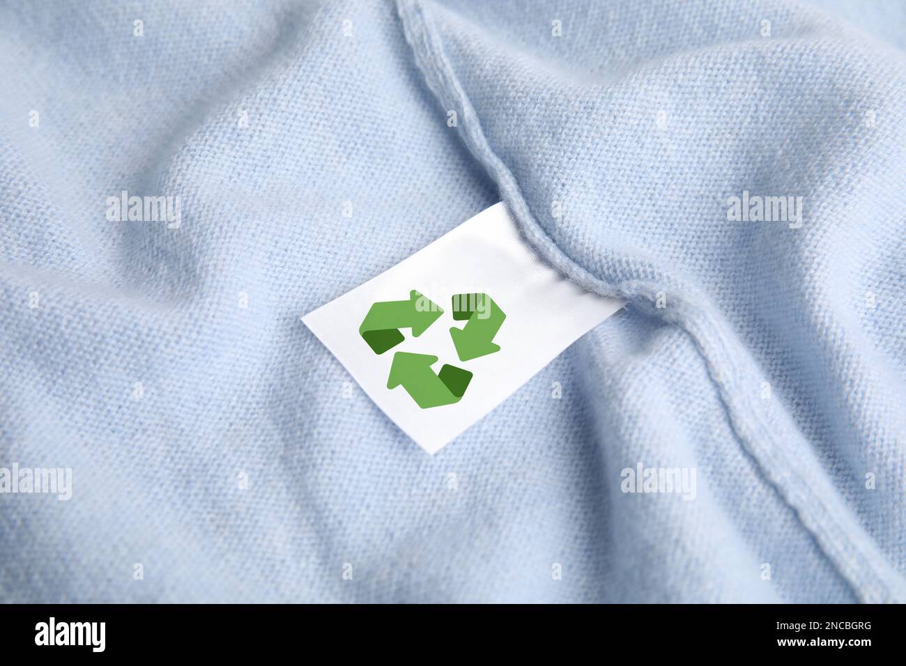 Clothing label with recycling label on cashmere sweater, closeup Stock