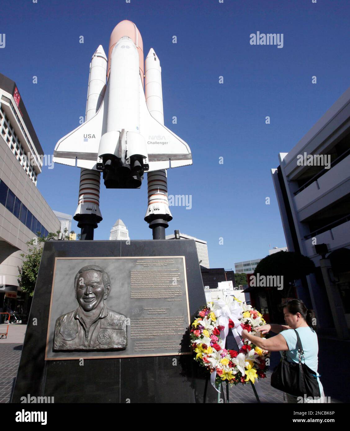 Lisa Shimamoto places flowers on a Challenger space shuttle memorial ...